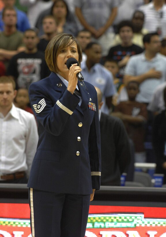 Tech. Sgt. Donna Siler sings the national anthem before the start of the College All-Star Basketball Game during the festivities leading up to the Final Four April 4 in San Antonio, Texas. Sergeant Siler is a vocalist for the Band of the West from Lackland Air Force Base, Texas. (U.S. Air Force photo/Tech. Sgt. Larry A. Simmons)