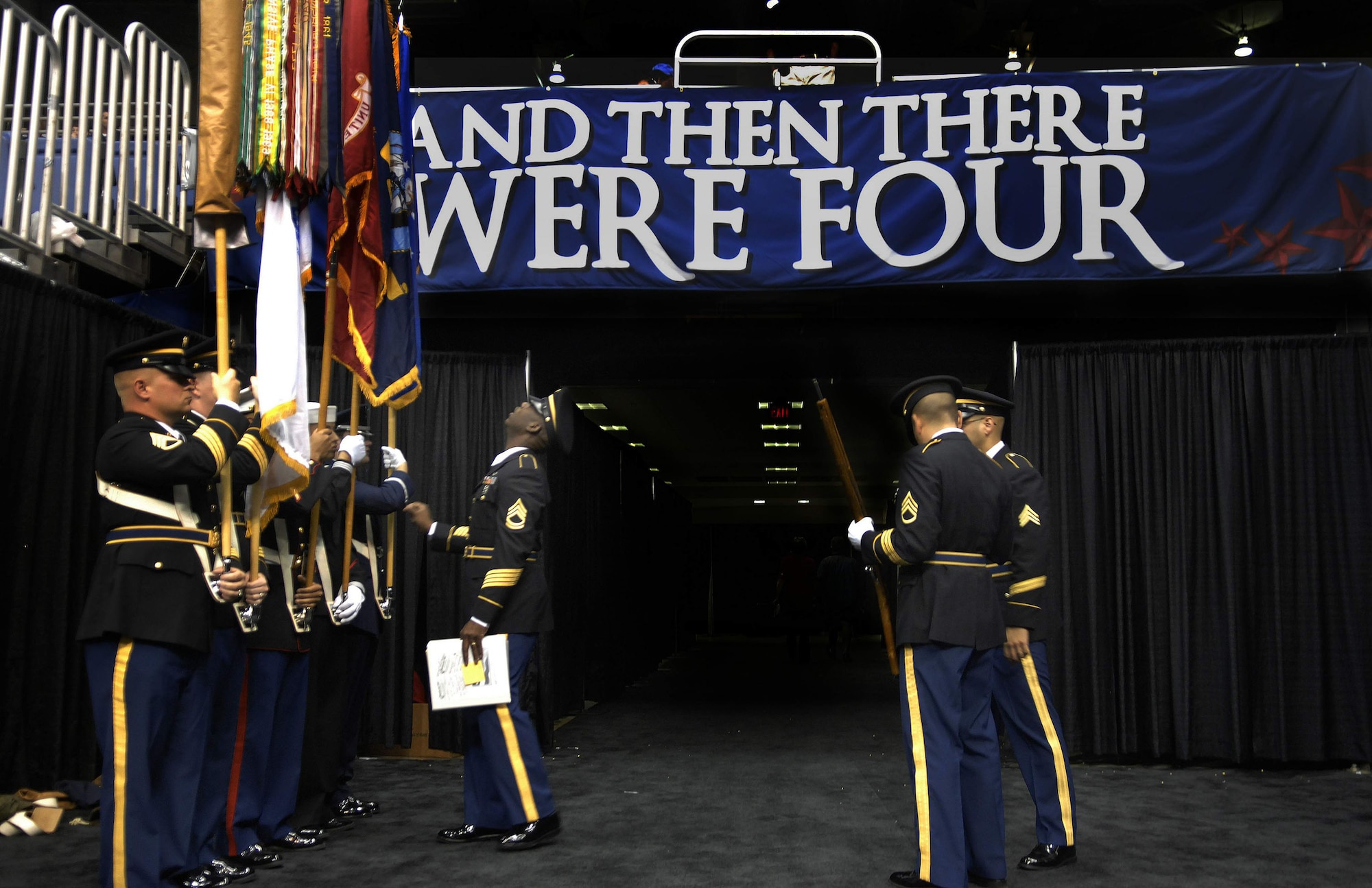 Army Sgt. 1st Class Richard James checks flag positions as the a multiservice color guard prepares before the start of the College All-Star Basketball Game during the festivities leading up to the Final Four April 4 in San Antonio, Texas. The color guard is from Fort Sam Houston, Texas. (U.S. Air Force photo/Tech. Sgt. Larry A. Simmons)