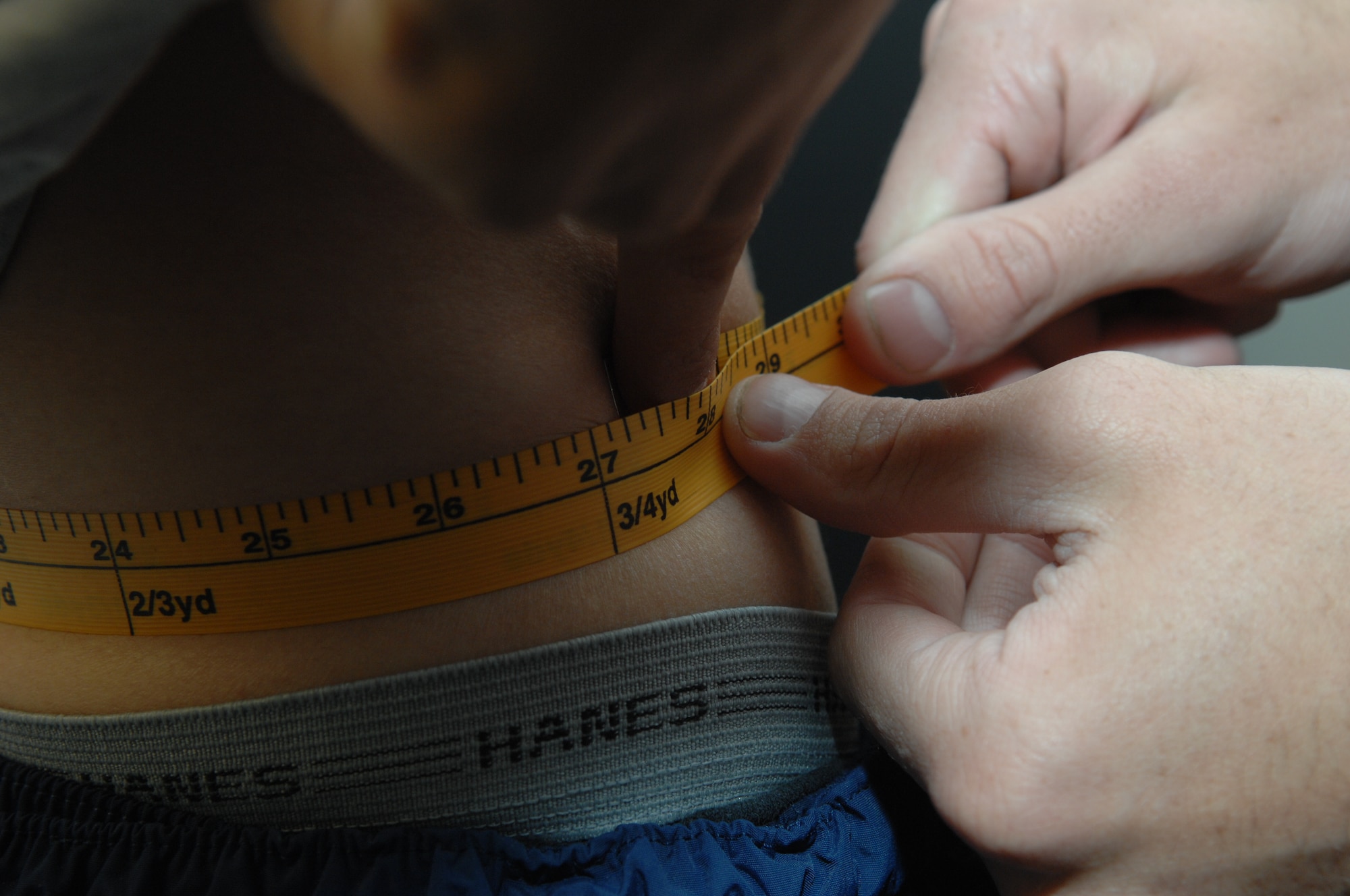Senior Airman Garrett Doyle, tapes an Airman's abdominal circumference April 4, at the fitness center on Holloman Air Force Base, N.M..  Airman Doyle is a Services Journeyman assigned to the 49th Force Support Squadron, 49th Fighter Wing. 
The Air Force physical fitness test focus on this variables used in the calculation are age, gender, abdominal circumference, number of push-ups completed, number of sit-ups completed, and time/score on an aerobic assessment.
(U.S. Air Force photo/Senior Airman Anthony Nelson Jr)