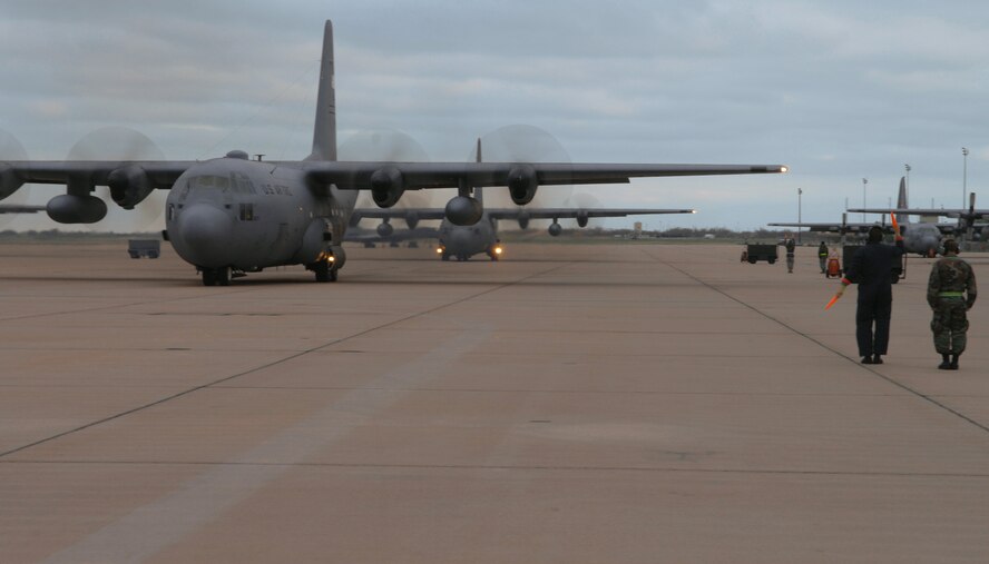 DYESS AIR FORCE BASE, Texas -- A group of C-130's begin to taxi, April 4. The C-130 will be one of the many military aircraft that will perform in the Big Country Airfest May 3. The gates open at 8 a.m., and demonstrations start at 10 a.m. (U.S. Air Force photo by Airman 1st Class Jennifer Romig)