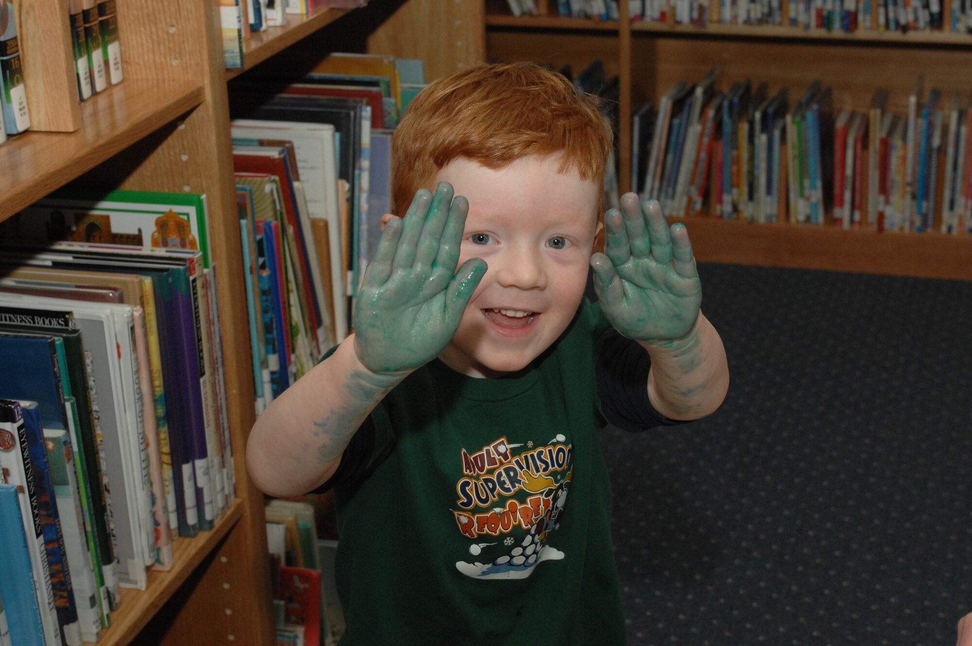 SPANGDAHLEM AIR BASE, Germany -- Daniel VanderZanden, 4, son of Katie and Staff Sgt. Nathan VanderZanden, 52nd Equipment Maintenance Squadron, shows off his paint-covered hands during Children's Reading Hour held at the Spangdahlem AB Library, April 3rd, 2008. (U.S. Air Force photo/Staff Sgt. Kristin Ruleau) 