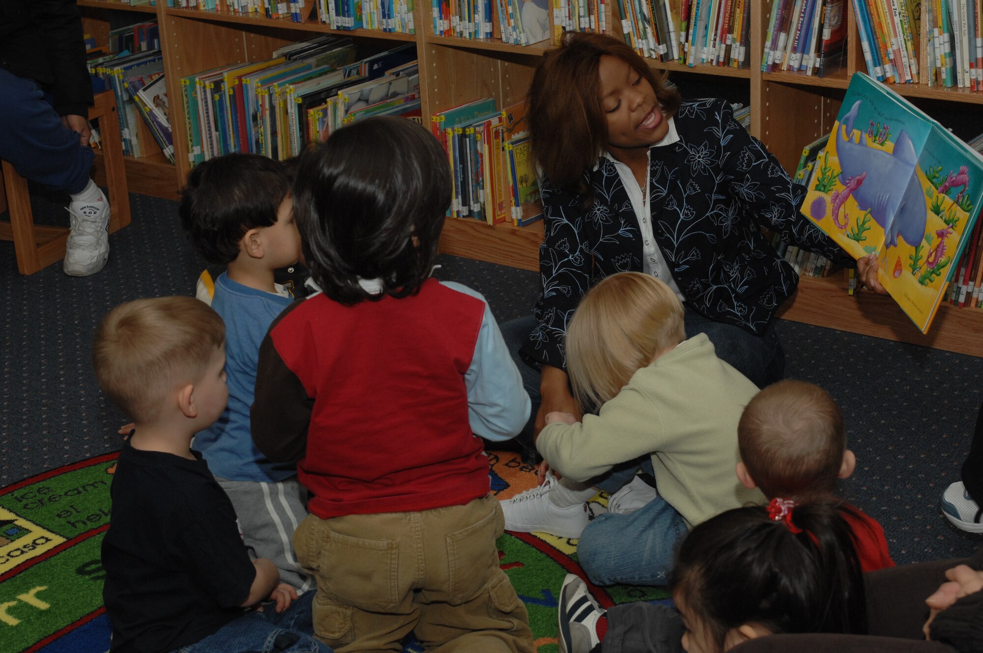 SPANGDAHLEM AIR BASE, Germany -- Carmen Gonzalez reads to a group of children during Children's Reading Hour held at the Spangdahlem AB Library, April 3rd, 2008. (U.S. Air Force photo/Staff Sgt. Kristin Ruleau) 