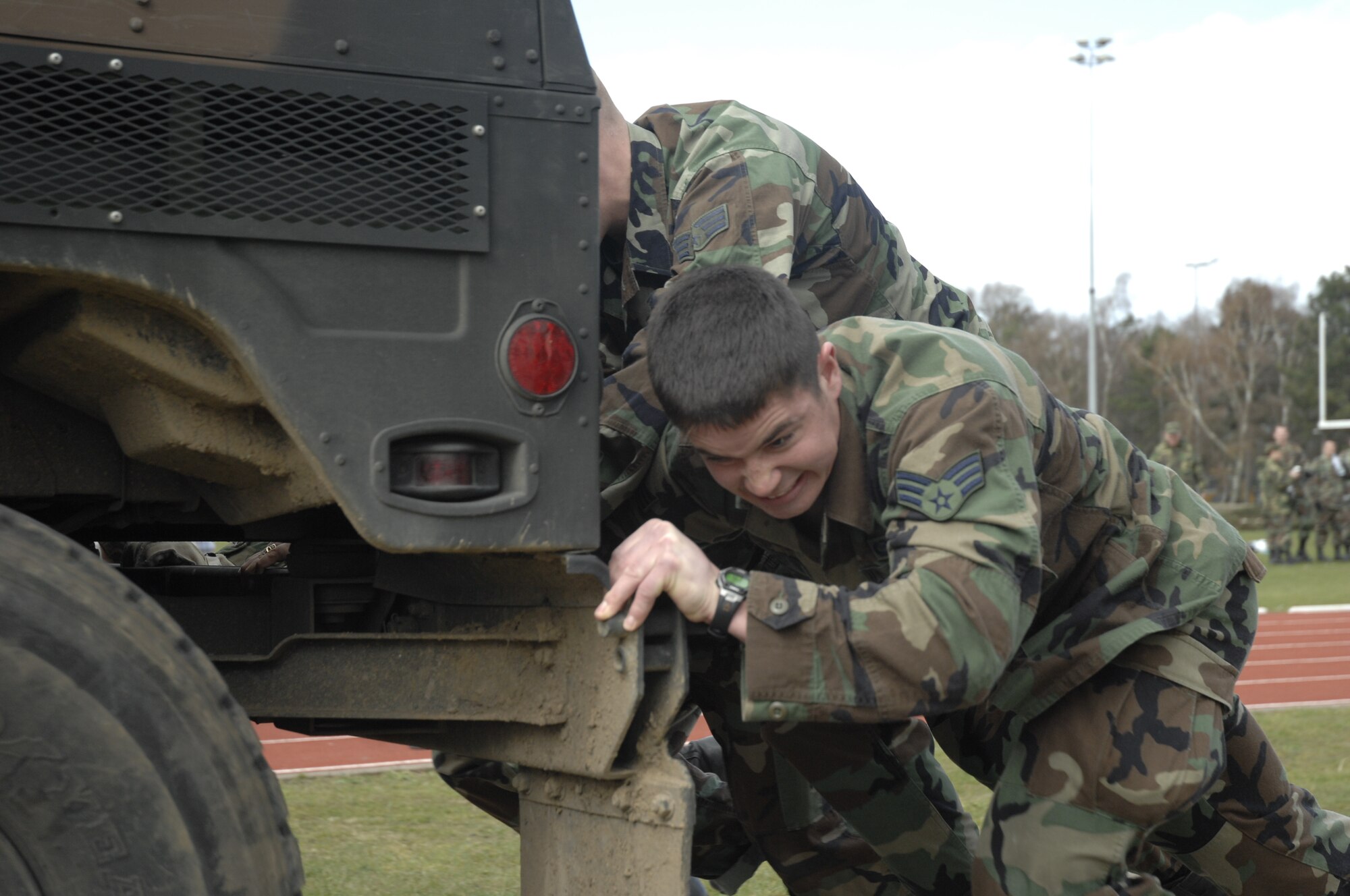 Senior Airman Joshua Wolf, 48th Communications Squadron, helps his squadron team push a HMMWV as part of the warrior games sponsored by 48th Services Squadron, April 1, RAF Lakenheath, England. (U.S. Air Force photo by Airman 1st Class Erika Brooke)

