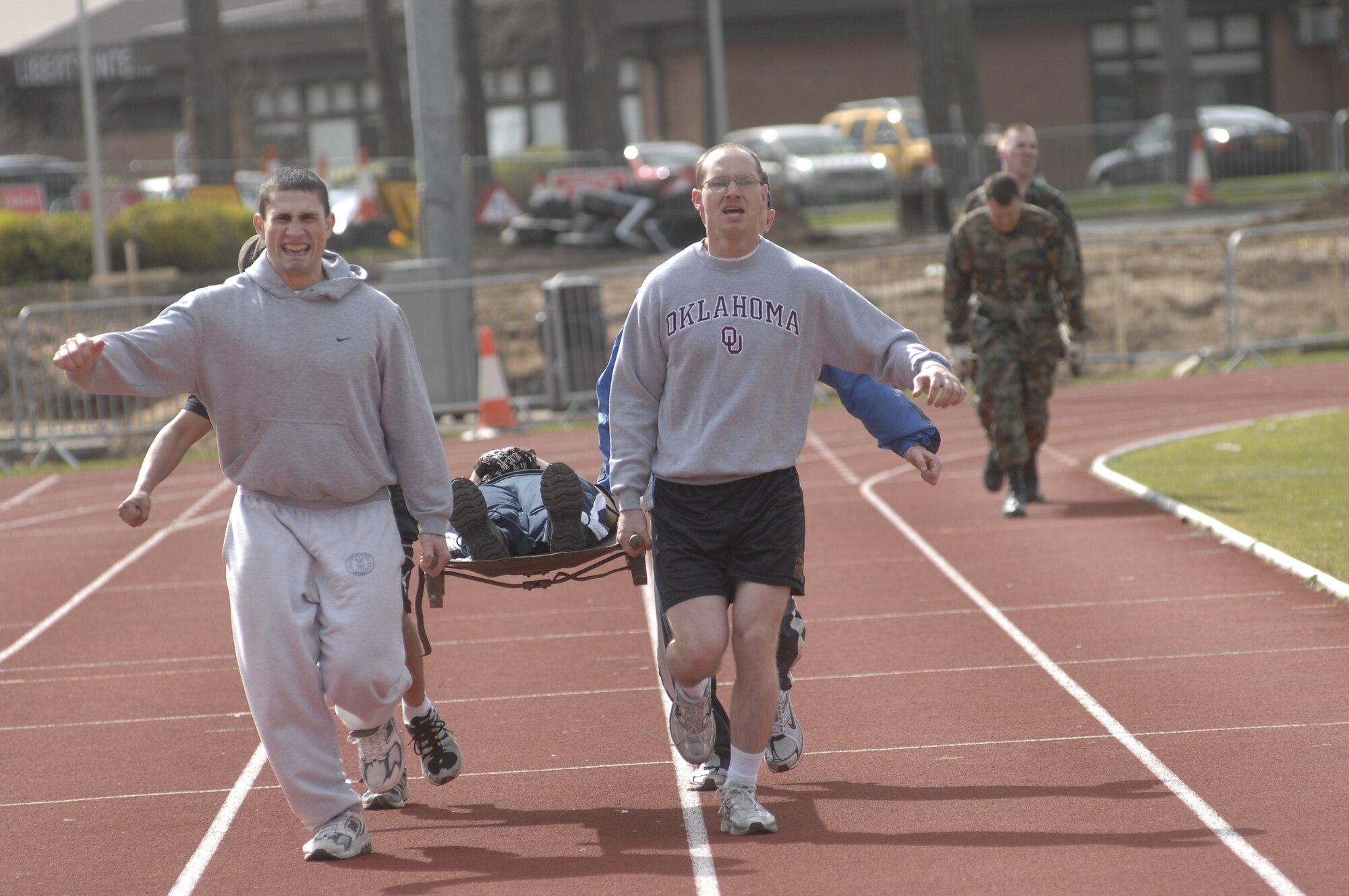 The 48th Logistics Readiness Squadron team, Staff Sgt. Eric Began, Airman 1st Class Brian Gunther, Airman 1st Class Phillip Hernandez, Staff Sgt. Kami Demnyan and Staff Sgt. David Hunter, pull forward to win the litter carry race during the warrior games sponsored by the 48th Services Squadron, April 1, RAF Lakenheath, England. (U.S. Air Force photo by Airman 1st Class Erika Brooke)