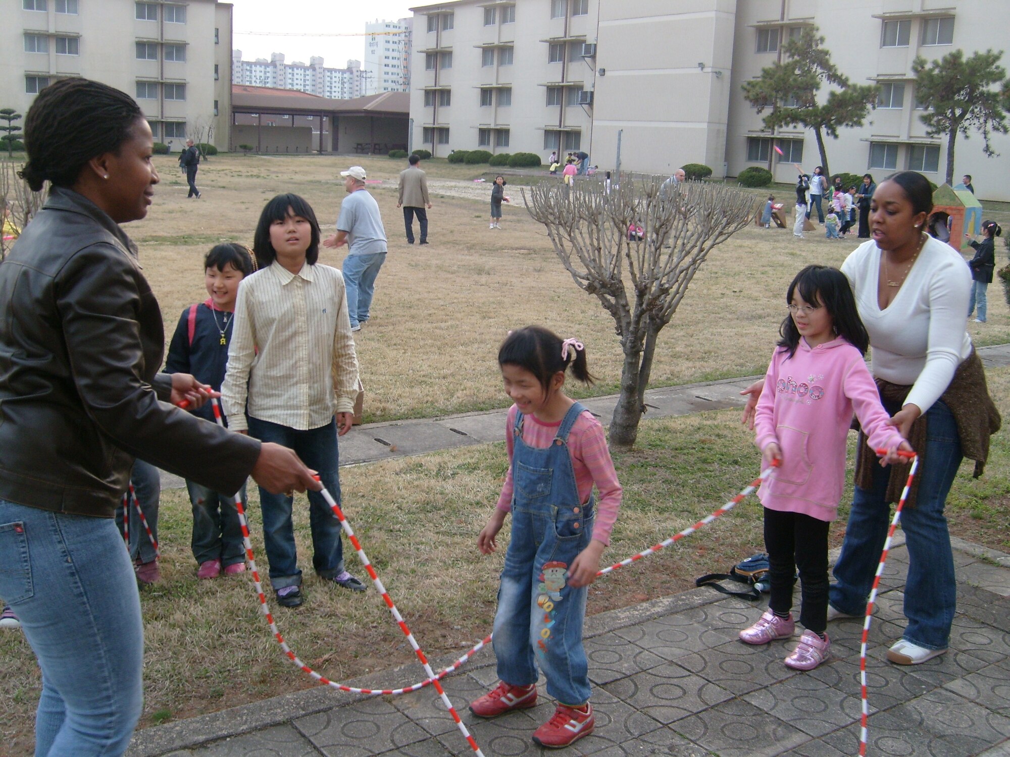 Gwangju Air Base, Republic of Korea -- Tech. Sgt. Melinda Oden and Staff Sgt. Camellia Love, 607th Material Maintenance Squadron, Detachment 1, play jump rope with children from the Song-Bin-Yo-Sa orphanage during the squadron’s Easter party April 4. (U.S. Air Force photo/Pak, Ki Hyon)