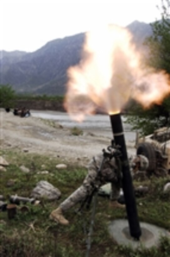 A U.S. Army soldier ducks away from the blast of a 120-mm mortar during operations south of Forward Operating Base Naray, Afghanistan, on March 26, 2008.  Soldiers from Headquarters and Headquarters Troop, 1st Battalion, 91st Cavalry Regiment, 173rd Airborne Brigade Combat Team are firing the mortar in hopes of flushing out anti-coalition militia suspected of attacking an Afghan supply truck.  