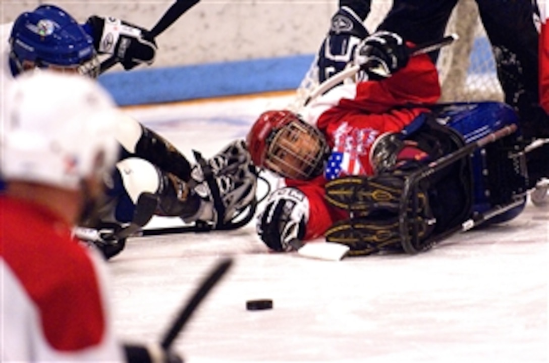 Disabled Marine Corp veteran, Gregory Rodriguez, stops a puck against the blue team at a sled hockey game during the 22nd National Disabled Veterans Winter Sports Clinic held at the Snowmass Village, Colo., April 2, 2008. The annual clinic instructs veterans on Alpine and Nordic skiing, rock climbing, snowmobiling, sled hockey, and more.
