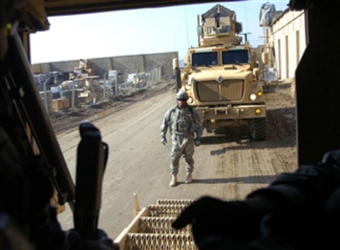 U.S. Army Command Sgt. Maj. Jim Champagne guides a mine resistant ambush protected vehicle onto Forward Operating Base Falcon, Iraq, April 5, 2008. Champagne is assigned to Multinational Division – Baghdad’s 4th Brigade Combat Team, 1st Infantry Division.
