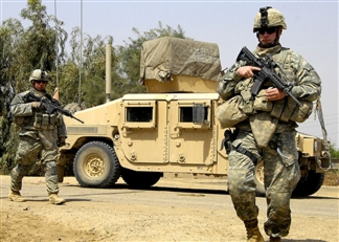 U.S. Army Sgt. 1st Class Cory West and Spc. John Bell prepare to search a house outside of Command Outpost Carver, Iraq, April 2, 2008, that was previously occupied by al Qaida operative Abu Ziyad. The soldiers are with the 3rd Infantry Divisions' 1st Battalion, 15th Infantry Regiment, 3rd Heavy Brigade Combat Team.