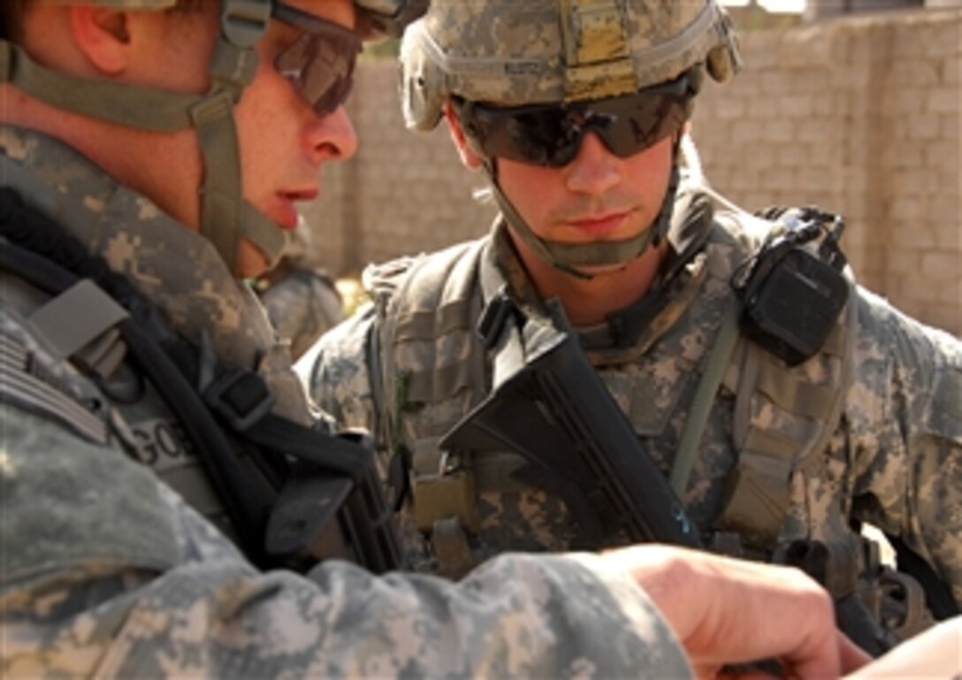 U.S. Army Staff Sgt. Terry Goble briefs Sgt. Robert Klotz before a joint patrol through a neighborhood in Shulla, Iraq, April 3, 2008. Goble and Klotz are assigned to the 101st Airborne Division's 1st Battalion, 502nd Infantry Regiment, 2nd Brigade Combat Team.