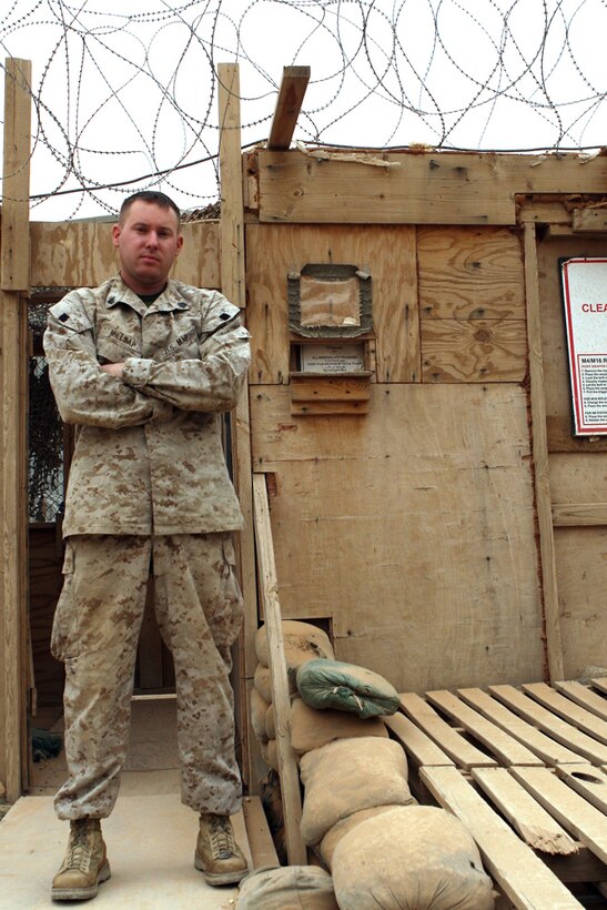 Sergeant Justin Millsap of Task Force 3rd Battalion, 2nd Marine Regiment, Regimental Combat Team 5 stands before the detainee collection point in Camp Al Qaâ??im, Iraq, April 8. Millsap, a native of Tonganoxie, Kan., is the noncommissioned officer-in-charge of the detainee collection point and is also the battalionâ??s Career Retention Specialist. ::r::::n:: (Photo by Cpl. Billy Hall)::r::::n::