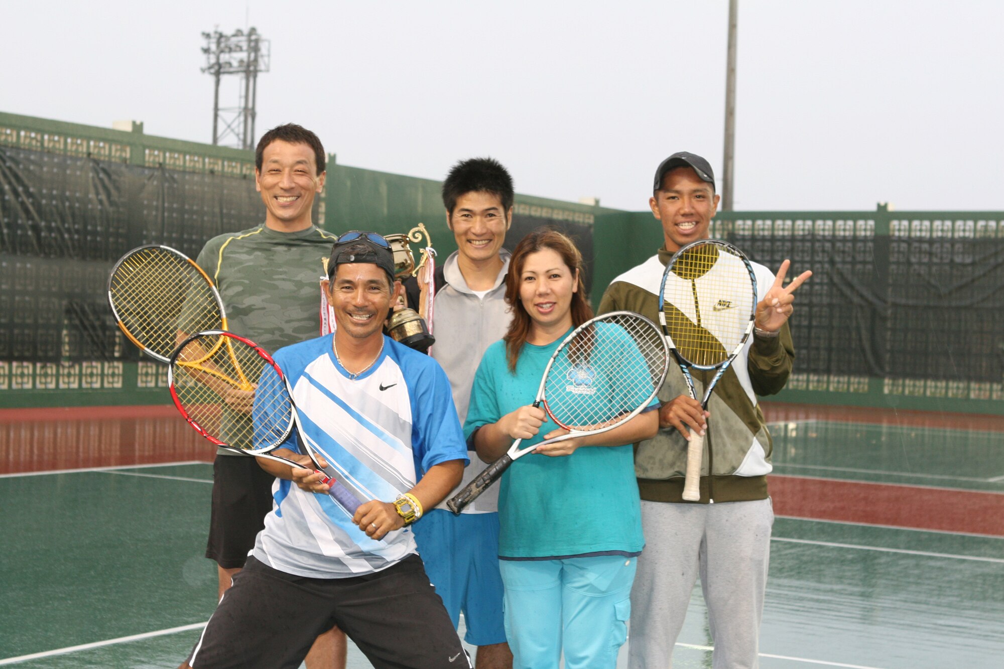 The Kadena tennis team poses after winning the Okinawa Team Championship Tennis Tournament in Naha April 5. The Kadena tennis team has won the title for three consecutive years. The team consists of six Japanese employees who work at Kadena. They will play in the national team tournament in Fukuoka, Japan, May 31 and June 1.  Pictured are (top) Hiro Iijima, Naoki Uchida, and Dai Yonamine, (bottom) Ken Higa and Kyomi Kinjo. Hiroshi Majikina, not pictured, was also a member of the team. (Photo by Chip Steitz)