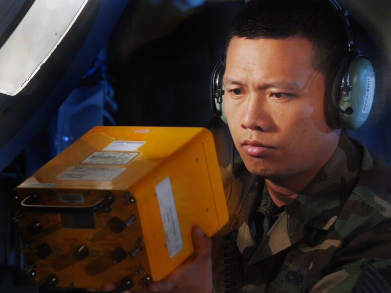 Technical Sgt. Truong Nguyen, an electronics warfare technician from the 452nd Maintenance Squadron, March Air Reserve Base, prepares to install a test set on the flare bucket of a C-17 Globemaster III cargo aircraft. (Photo by Val Gempis)