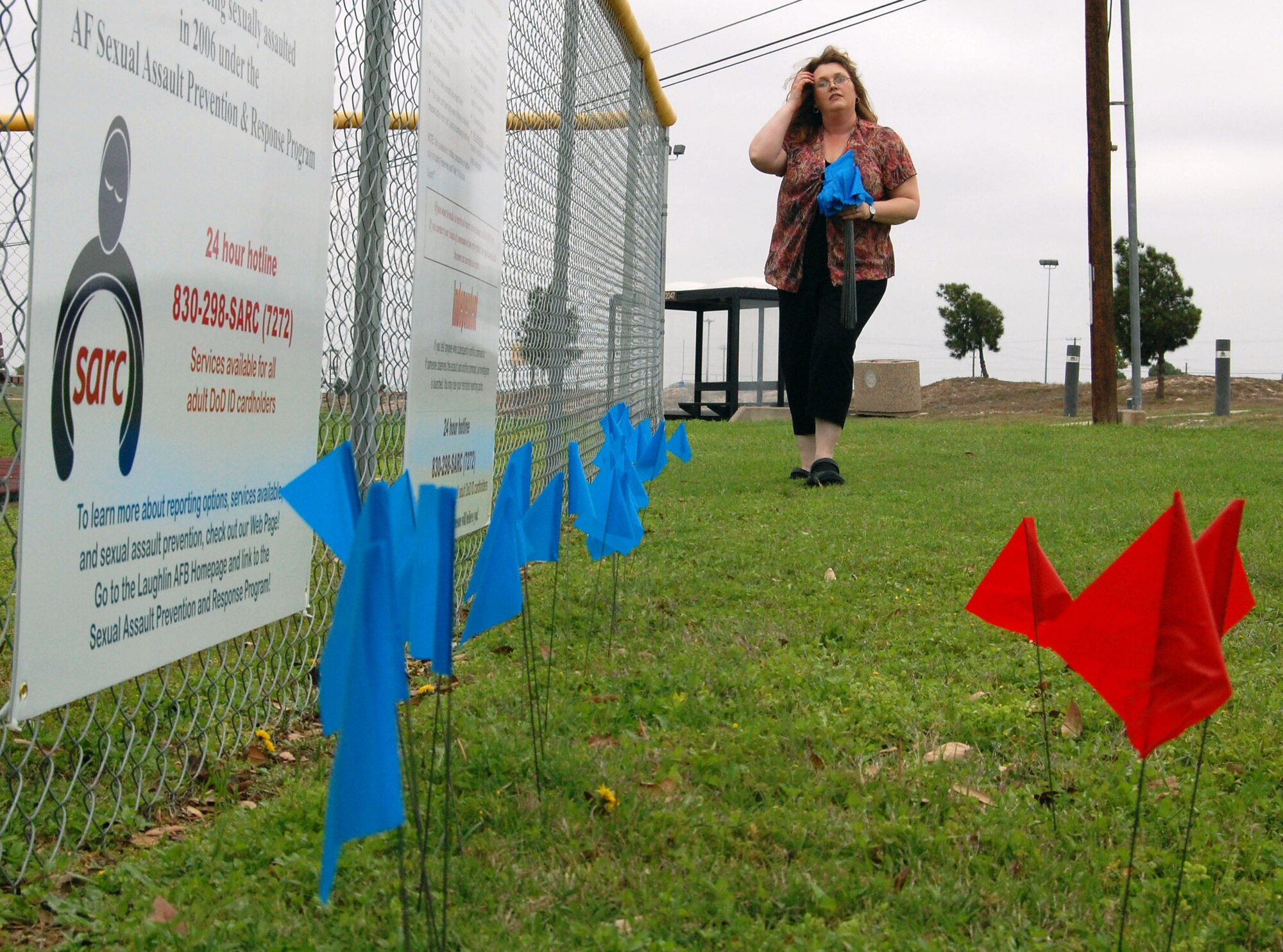 LAUGHLIN AIR FORCE BASE, Texas-- Sabrina Pena, 47th Flying Training Wing Sexual Assault Response Coordinator, places flags in the lawn at Su Casa April 7.  The flags are part of this month’s Sexual Assault Awareness Campaign and were placed to raise awareness on preventing and reporting sexual assault incidents.    