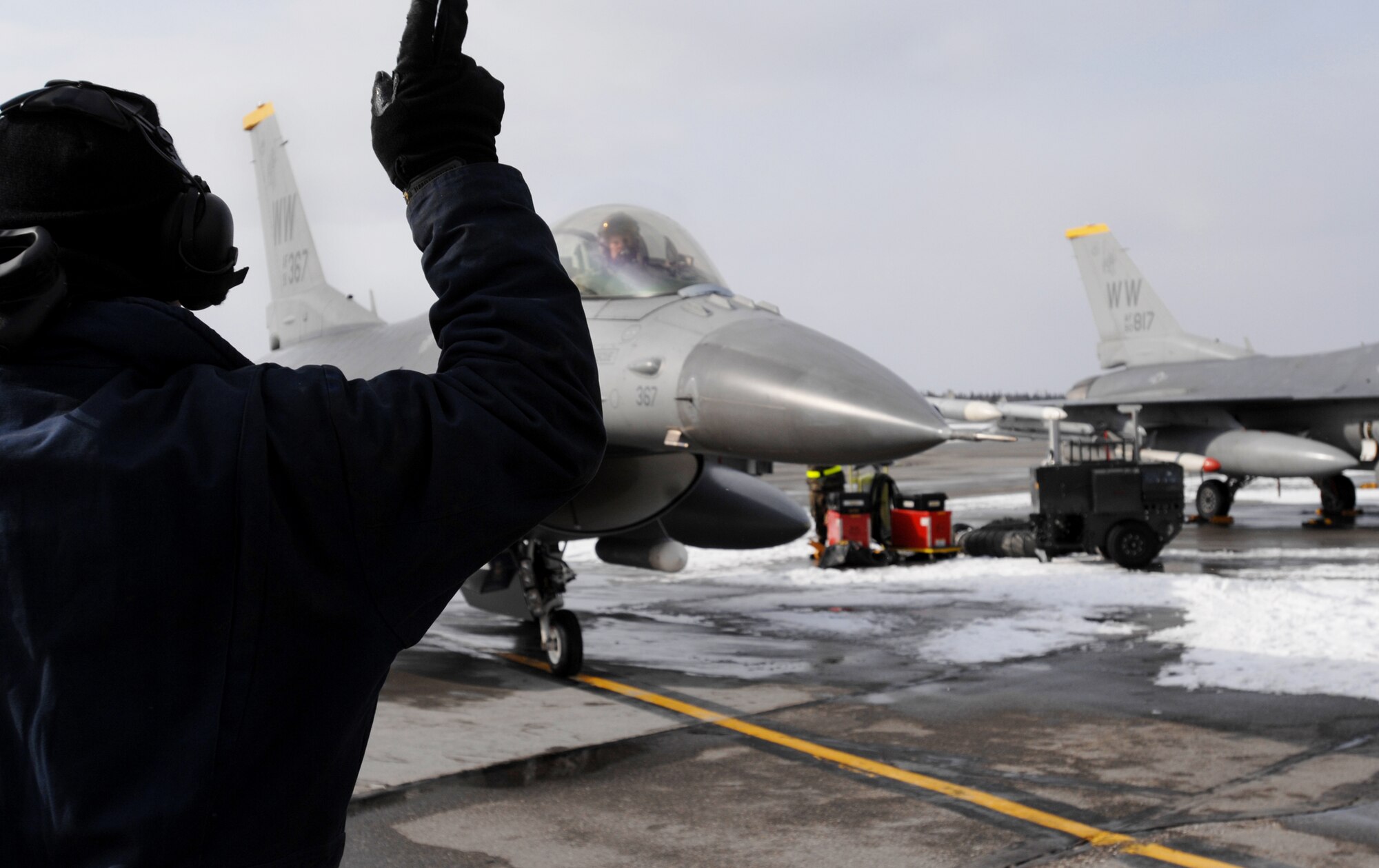 Senior Airman Christopher Moorhead, a crew chief from the 14th Aircraft Maintenance Unit, Misawa Air Base, Japan marshals out an F-16 Fighting Falcon, also from Misawa Air Base for a training sortie over the Pacific Alaska Range Complex on April 7, 2008. Red Flag-Alaska is a series of Pacific Air Forces field training exercises for U.S Forces and allies that provide joint offensive counter-air, indirection, close air support, and large force employment training in a simulated combat environment.

(U.S Air Force Photo by Technical Sgt. Eric T. Sheler)
