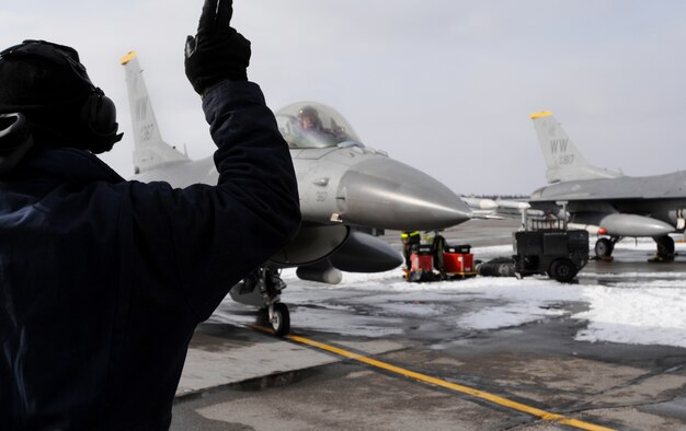 Senior Airman Christopher Moorhead, a crew chief from the 14th Aircraft Maintenance Unit, Misawa Air Base, Japan marshals out an F-16 Fighting Falcon, also from Misawa Air Base for a training sortie over the Pacific Alaska Range Complex on April 7, 2008. Red Flag-Alaska is a series of Pacific Air Forces field training exercises for U.S Forces and allies that provide joint offensive counter-air, indirection, close air support, and large force employment training in a simulated combat environment.

(U.S Air Force Photo by Technical Sgt. Eric T. Sheler)
