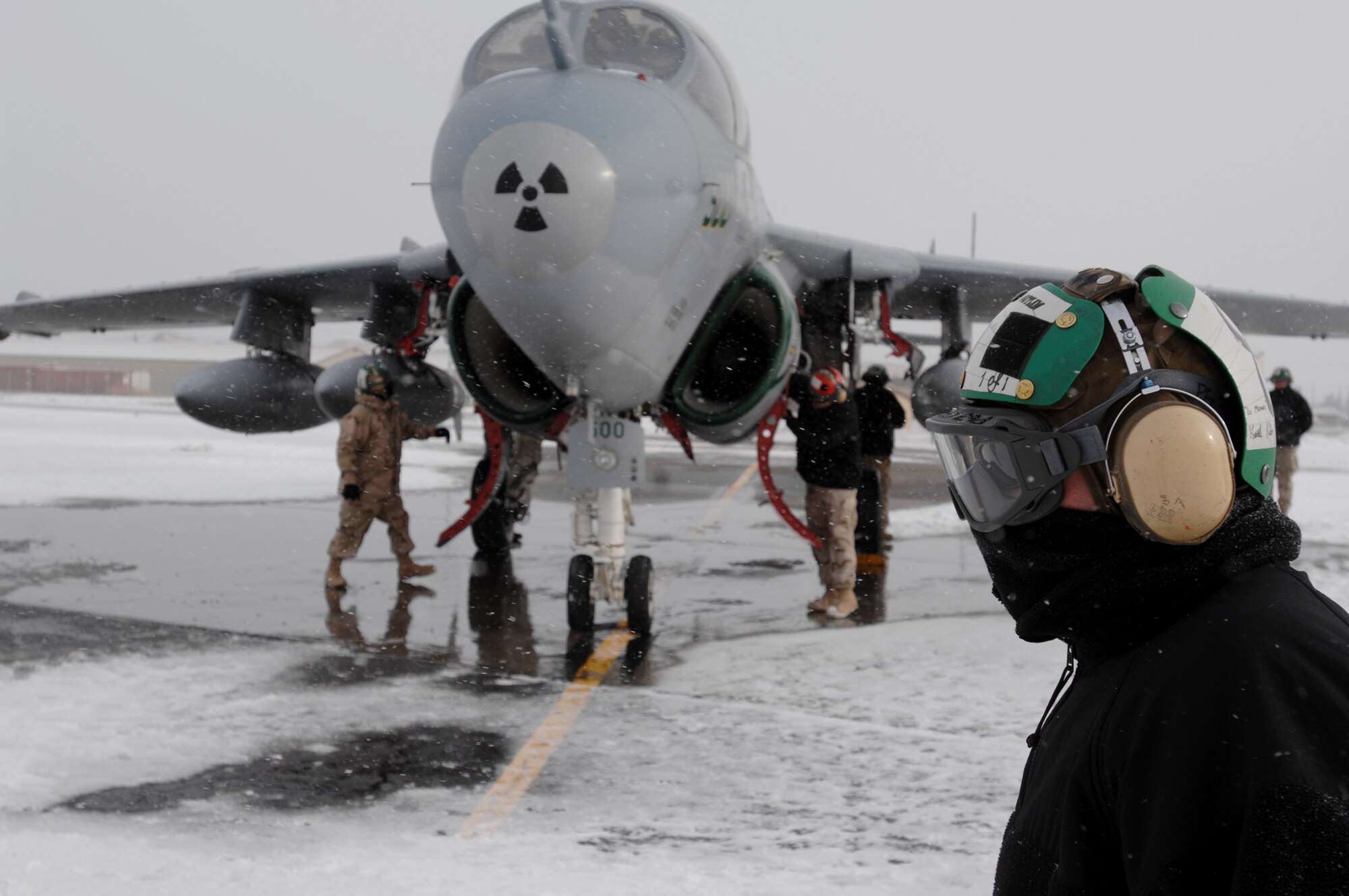 U.S Navy Petty Officer Second Class Wyatt Zarr walks in the snow and harsh Alaska temperature past an EA-6B Prowler aircraft while Navy aircraft maintenance personnel perform pre-flight maintenance on the aircraft on April 7, 2008 at Eielson Air Force Base, Alaska. The Navy Prowler unit is from Naval Air Station Whidbey Island and is participants of the Red Flag-Alaska 08-02 exercise.   Red Flag-Alaska is a series of Pacific Air Forces field training exercises for U.S Forces and allies that provide joint offensive counter-air, indirection, close air support, and large force employment training in a simulated combat environment.

(U.S Air Force Photo by Technical Sgt. Eric T. Sheler)
