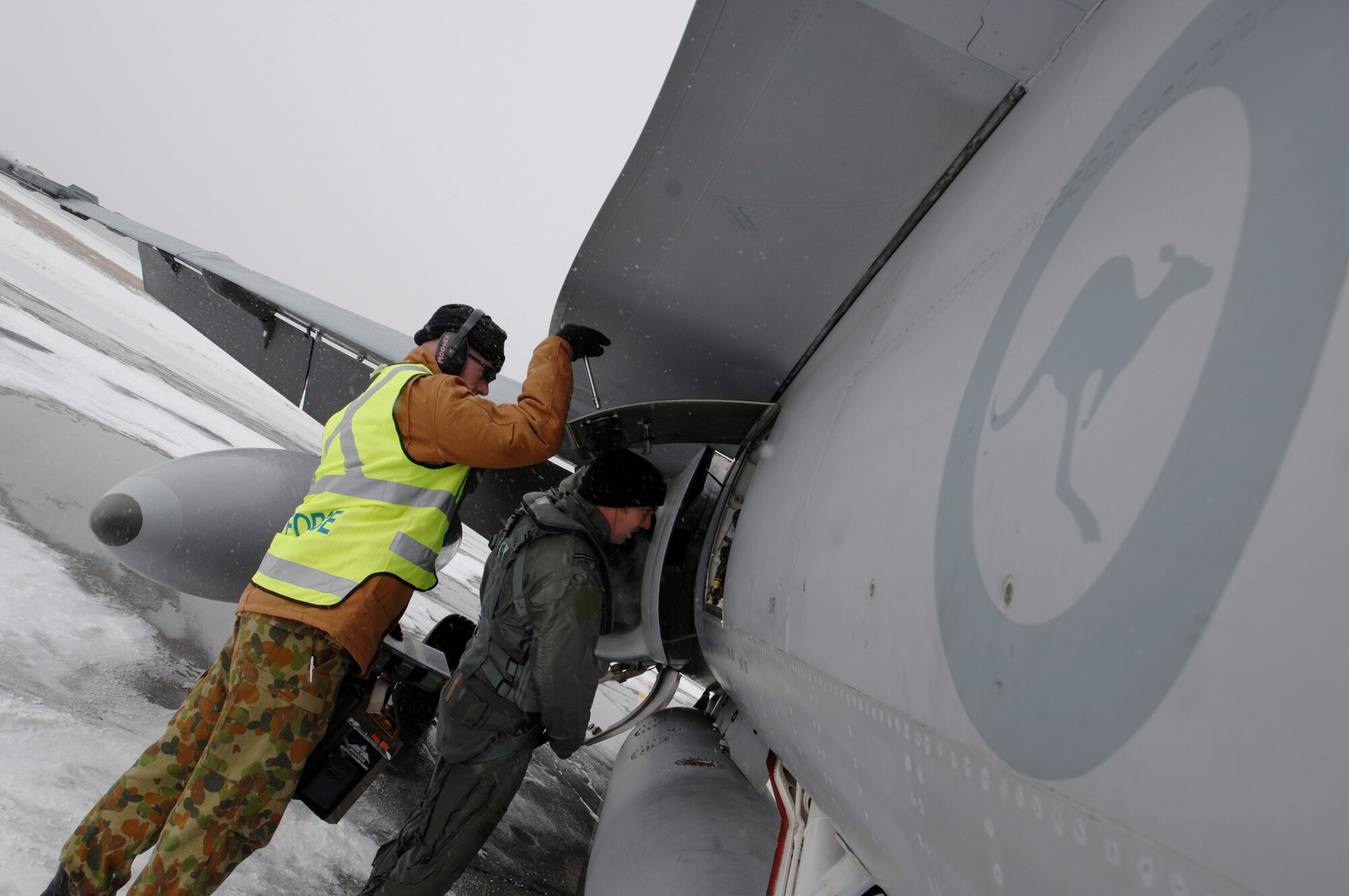 Australian Air Force Corporal Adrian Moore (left), an armament technician from the 75 Squadron lifts a side panel of a Australian FA-18 Hornet fighter jet so FA-18 Hornet pilot Flying Officer Todd Brown can inspect some of the components of the fighter jet prior to his training sortie over the Pacific Alaska Range Complex on April 7, 2008 at Eielson Air Force Base, Alaska. The 75th Squadron from the Australian Air Force is participants of the Red Flag-Alaska 08-02 exercise.   Red Flag-Alaska is a series of Pacific Air Forces field training exercises for U.S Forces and allies that provide joint offensive counter-air, indirection, close air support, and large force employment training in a simulated combat environment.

(U.S Air Force Photo by Technical Sgt. Eric T. Sheler)
