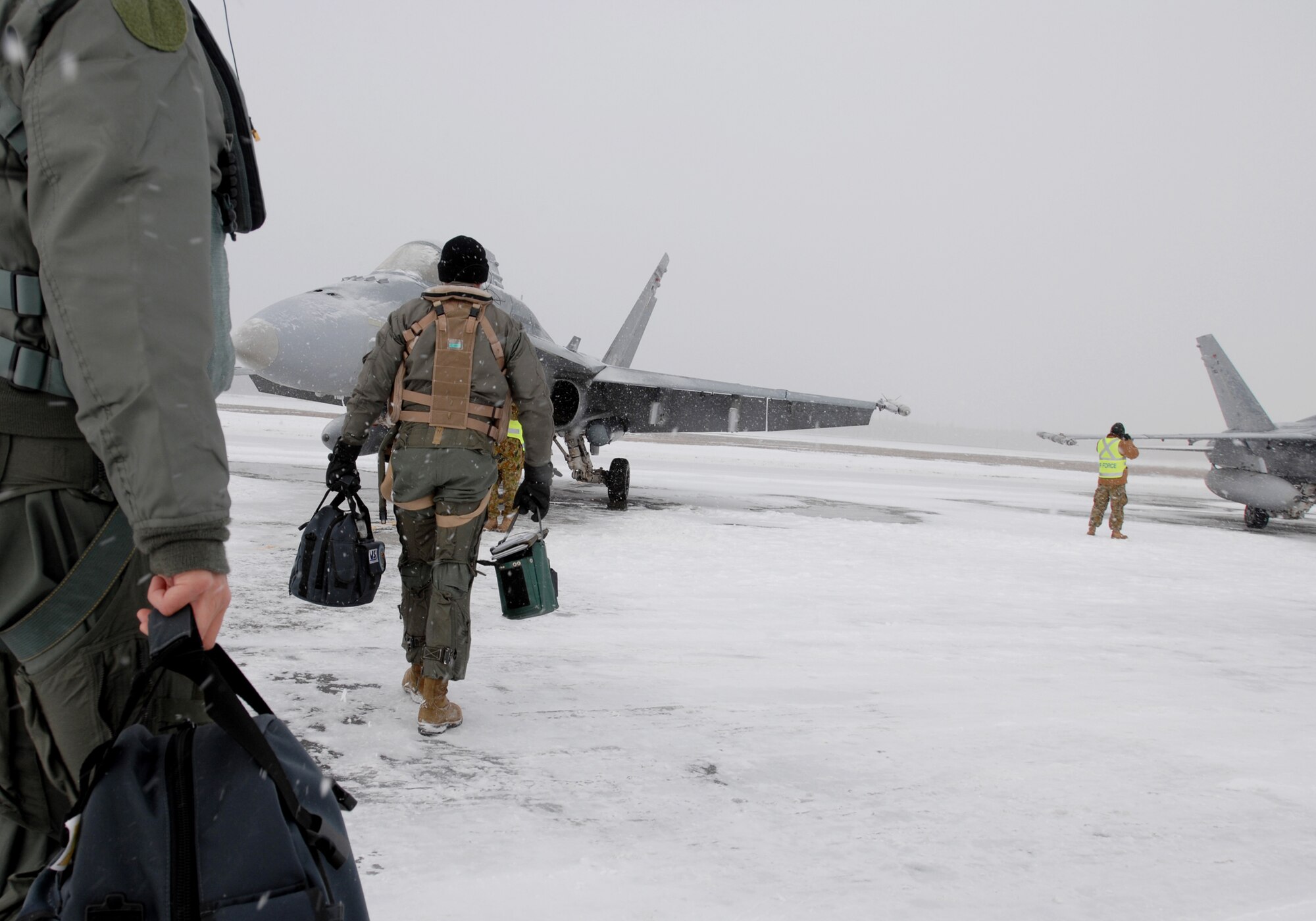 Australian fighter pilots Flying Officer Todd Brown (left) walks behind Wing Commander Rob Chipman through the snow on their way to their  Australian FA-18 Hornet fighter jets sitting on the flight line for their training sortie over the Pacific Alaska Range Complex on April 7, 2008 at Eielson Air Force Base, Alaska. The 75th Squadron from the Australian Air Force is participants of the Red Flag-Alaska 08-02 exercise.   Red Flag-Alaska is a series of Pacific Air Forces field training exercises for U.S Forces and allies that provide joint offensive counter-air, indirection, close air support, and large force employment training in a simulated combat environment.

(U.S Air Force Photo by Technical Sgt. Eric T. Sheler)
