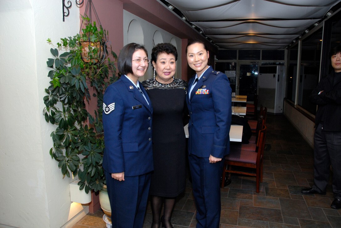 OSAN AIR BASE, Republic of Korea--While entertaining more than 380 service members last Friday's Korea-America Good Neighbor Society concert and dinner, a popular Korean pop singer pauses for a photo with volunteers Staff Sgt. Sandra Silvia 621st Air Control Squadron (left) and Lt Yoon Yesun (right). The KAGNS funded and hosted the event honoring service members and their families. (U.S. Air Force photo/Staff Sgt. Scottie McCord)
