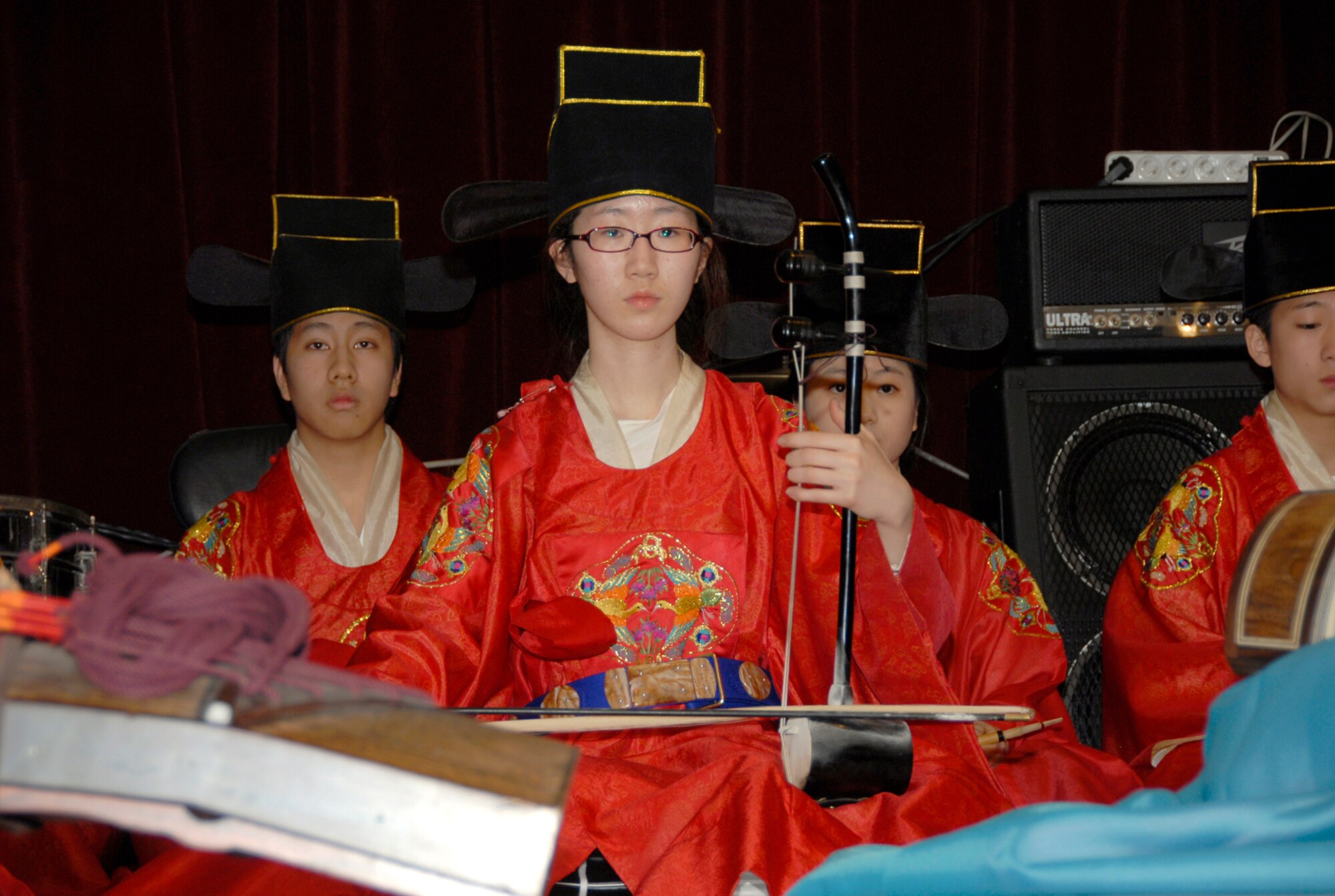 OSAN AIR BASE, Republic of Korea--Lt Gen Steve Wood, Seventh Air Force commander, presents Numbered Air Force coins to Korean high students who performed traditional Korean music during last Friday's Korea-America Good Neighbor Society concert and dinner. KAGNS Chairman Kim Yoon Phil hosted the event honoring more than 380 service members and their families.  (U.S. Air Force photo/Staff Sgt. Scottie McCord)