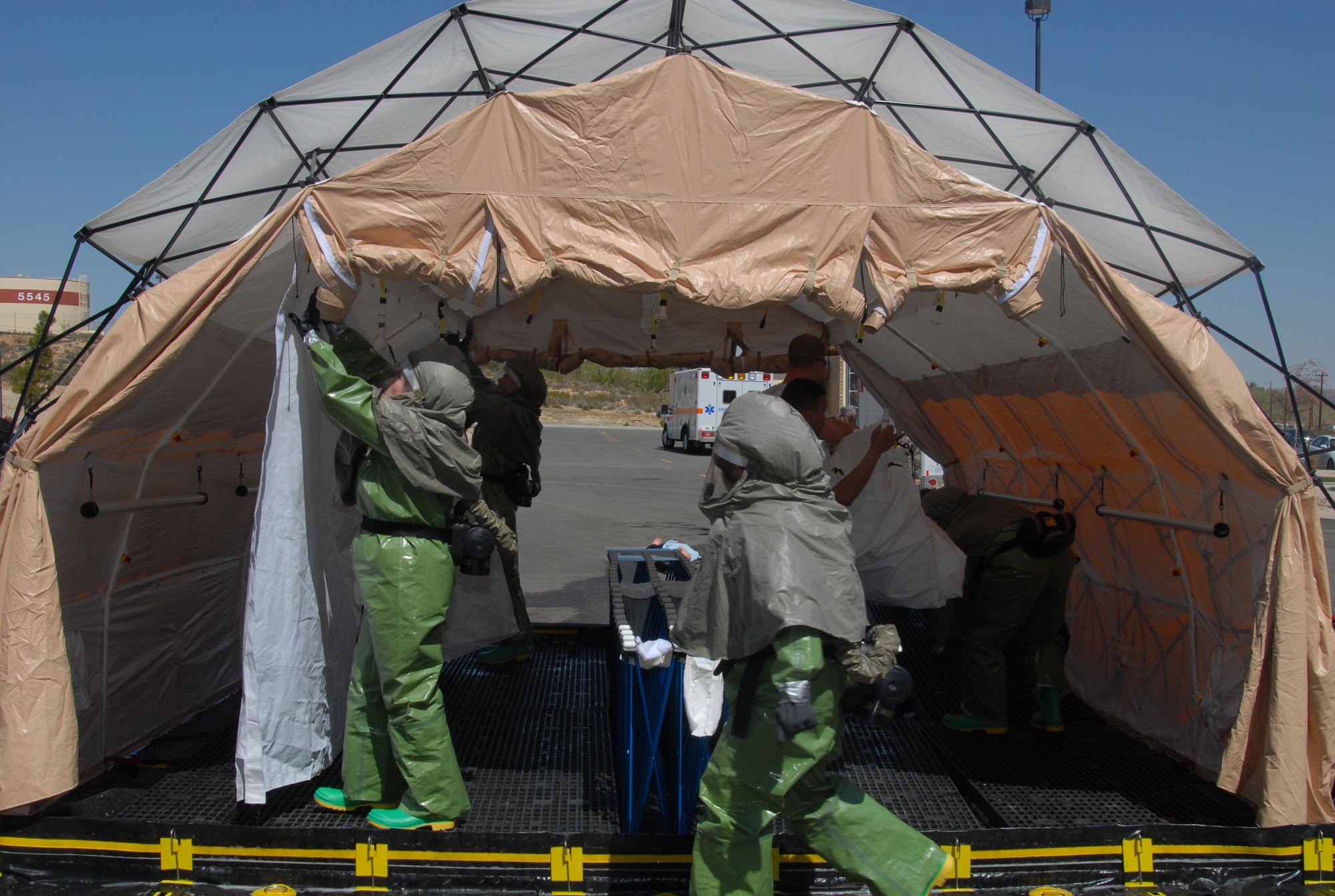 The 95th Medical Group builds an in-place patient decontamination capability during an IPPDC training here April 1 and 2. During the training the team registered the second fastest mission capable time of IPPDC equipment set up with a time of four minutes and 12 seconds. The record is four minutes and six seconds. (Air Force photo by Senior Airman Julius Delos Reyes)
