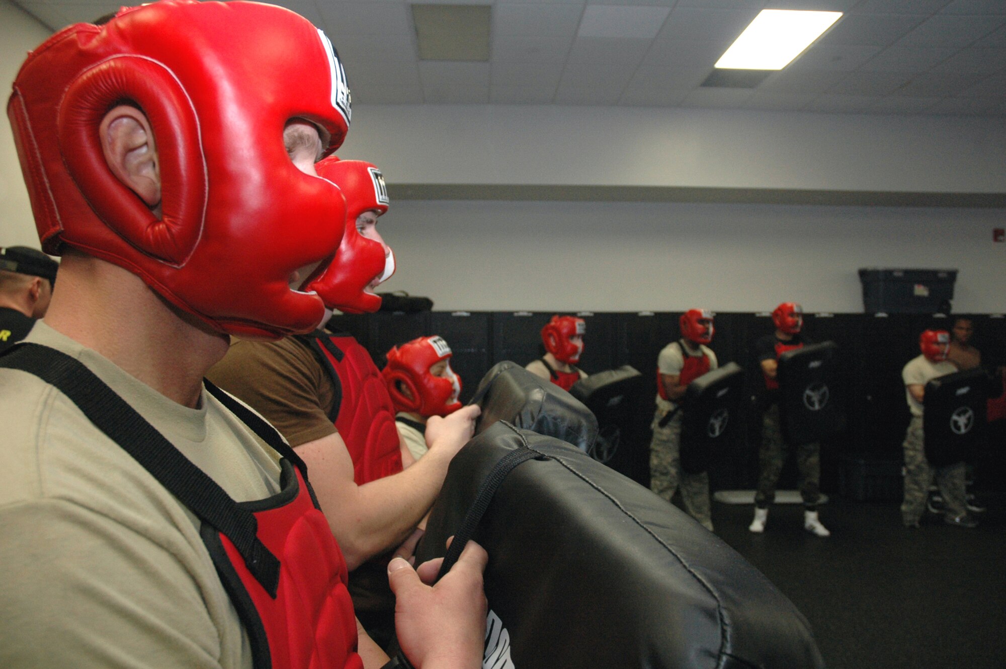 Students in the Air Force Phoenix Raven Course are dressed in protective gear as they practice self defense moves using a baton against an "aggressor" in a red-man suit during training April 4, 2008, in the U.S. Air Force Expeditionary Center on Fort Dix, N.J.  The course, taught by the Center's 421st Combat Training Squadron, teaches Air Force security forces, Army military police and Navy security forces in areas of self defense, aircraft security, verbal judo and many related courses.  (U.S. Air Force Photo/Tech. Sgt. Scott T. Sturkol)