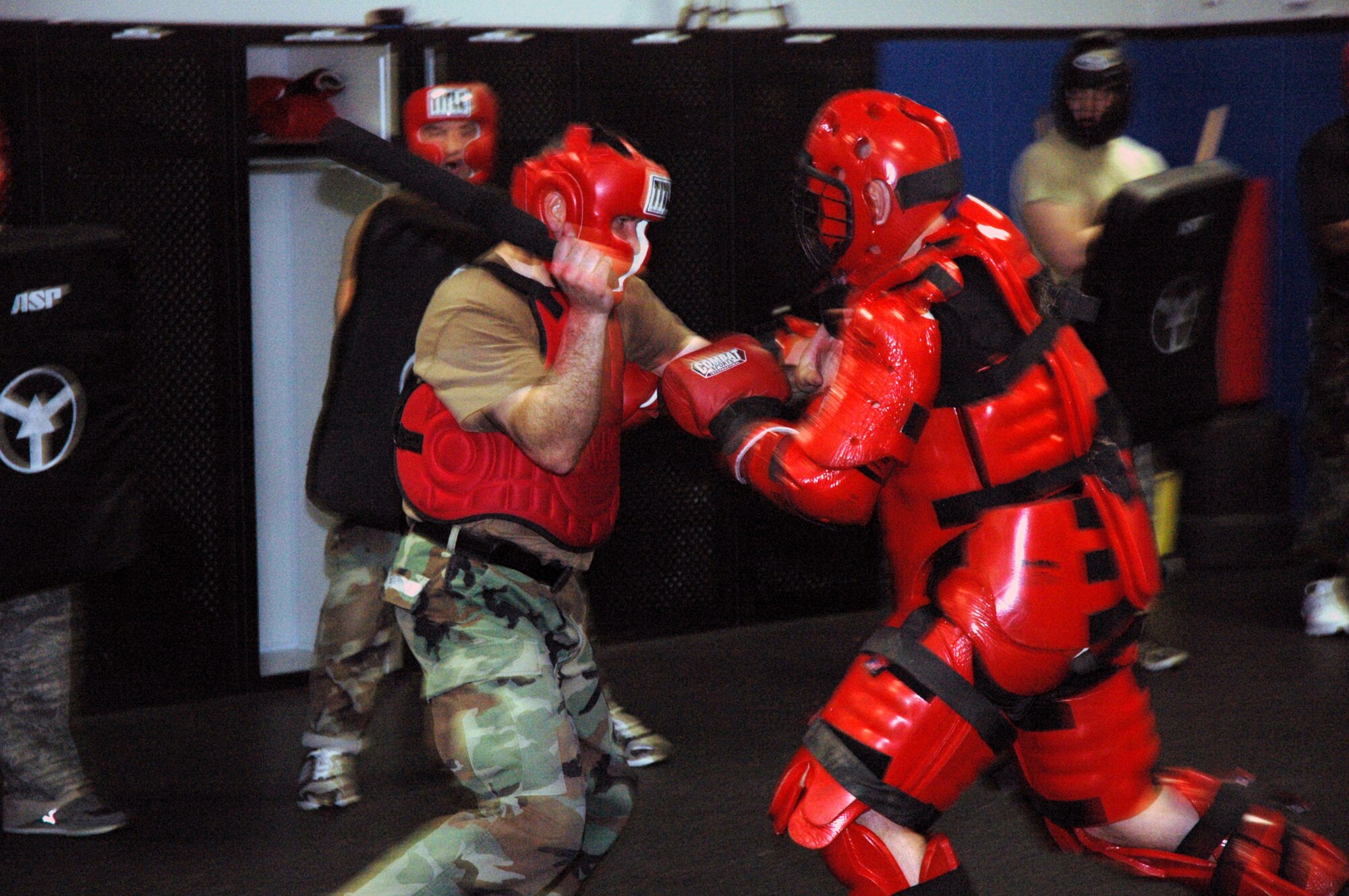 Students in the Air Force Phoenix Raven Course practice self defense moves using a baton with an "aggressor" in a red-man suit during training April 4, 2008, in the U.S. Air Force Expeditionary Center on Fort Dix, N.J.  The course, taught by the Center's 421st Combat Training Squadron, teaches Air Force security forces, Army military police and Navy security forces in areas of self defense, aircraft security, verbal judo and many related courses.  (U.S. Air Force Photo/Tech. Sgt. Scott T. Sturkol)