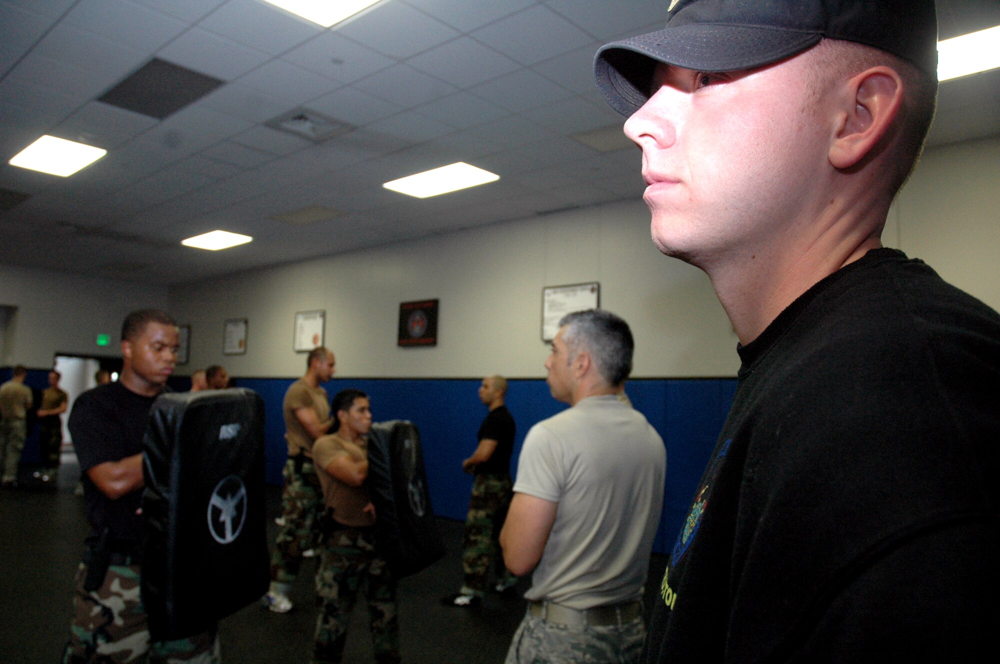 Tech. Sgt. Ryan Thompson, Phoenix Raven course instructor from the U.S. Air Force Expeditionary Center's 421st Combat Training Squadron, watches over self defense training for Raven students April 4, 2008, in the Center on Fort Dix, N.J.  The course, taught by the Center's 421st Combat Training Squadron, teaches Air Force security forces, Army military police and Navy security forces in areas of self defense, aircraft security, verbal judo and many related courses.  (U.S. Air Force Photo/Tech. Sgt. Scott T. Sturkol)