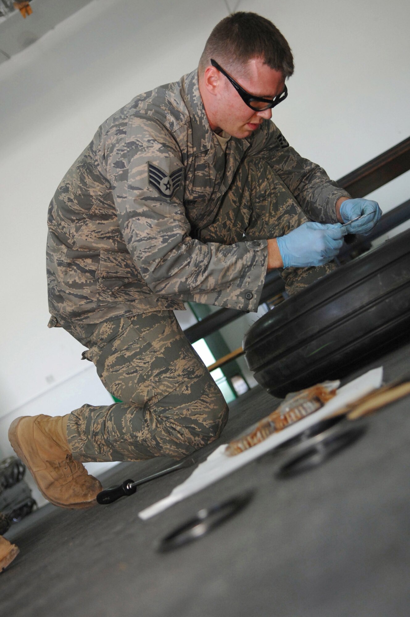 Staff Sgt. Joshua Banner replaces retaining rings on an F-16 Fighting Falcon's main landing gear wheel at Balad Air Base, Iraq. The 332nd Expeditionary Maintenance Squadron provides combat-ready aircraft and munitions to the air component commander in support of coalition forces throughout Iraq. Sergeant Banner is a 332nd EMXS crew chief deployed from Seymour Johnson Air Force Base, N.C. (U.S. Air Force photo/Senior Airman Julianne Showalter) 