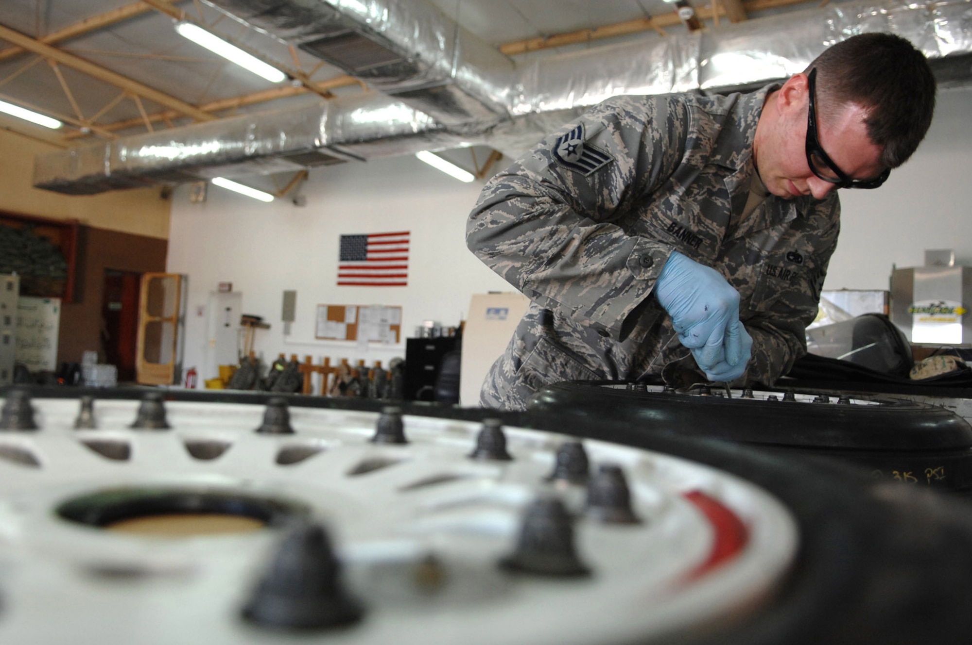Staff Sgt. Joshua Banner replaces retaining rings on an F-16 Fighting Falcon's main landing gear wheel at Balad Air Base, Iraq. The 332nd Expeditionary Maintenance Squadron provides combat-ready aircraft and munitions to the air component commander in support of coalition forces throughout Iraq. Sergeant Banner is a 332nd EMXS crew chief deployed from Seymour Johnson Air Force Base, N.C. (U.S. Air Force photo/Senior Airman Julianne Showalter) 
