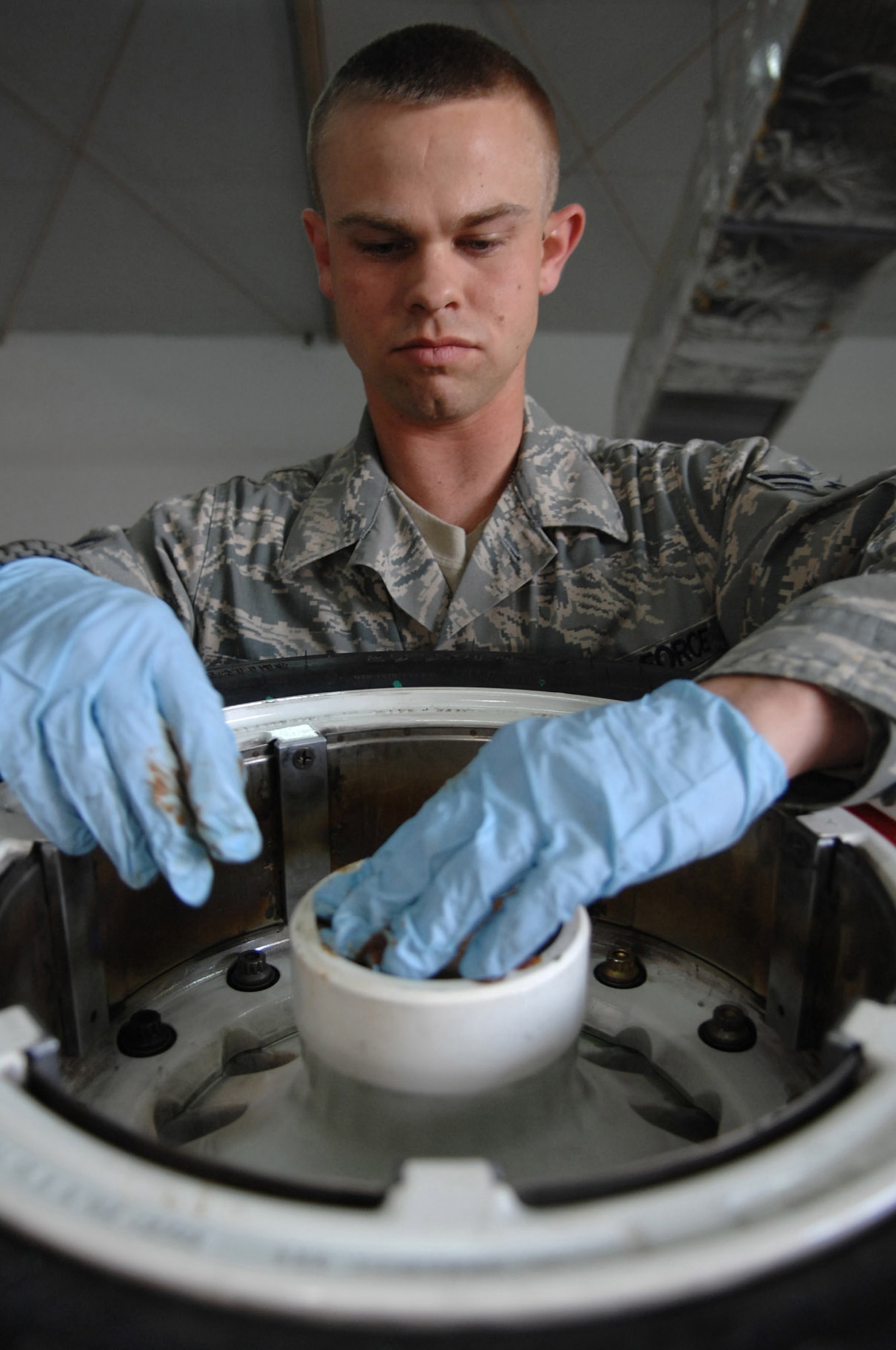 Airman 1st Class Jared Hollers replaces retaining rings on an F-16 Fighting Falcon's main landing gear wheel at Balad Air Base, Iraq. The rings allow the wheels to roll smoothly and must be changed after every 15 missions during combat operations. Airman Hollers is a 332nd Expeditionary Maintenance Squadron crew chief deployed from Hill Air Force Base, Utah. (U.S. Air Force photo/Senior Airman Julianne Showalter) 