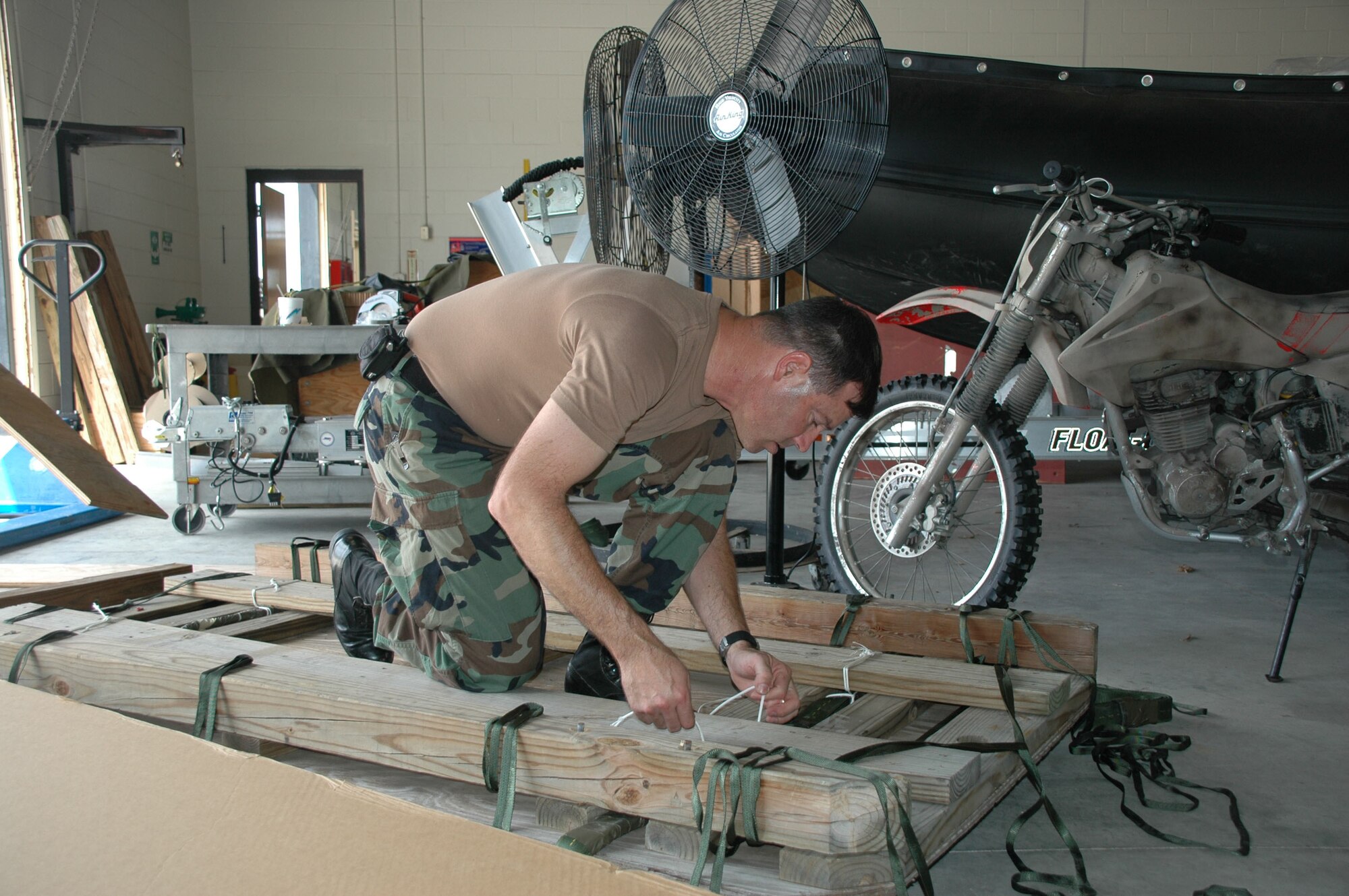 Rescue Reservist Tech. Sgt. Michael Fuller, 920th Rescue Wing Life Support Technician, assembles a four-wheeler quad bundle at Patrick Air Force Base, Fla., to ready it for airdrop from an HC-130P/N Extended-Range Hercules aircraft.  The quad will deploy along with pararescuemen (PJs) from the back of the aircraft as part of pararescue jump training.  PJs train extensively using a variety of equipment to for  rescuing isolated personnel behind enemy lines during wartime.  Sergeant Fuller and other life support personnel like him, are vital in readying life-saving equipment.  Each quad bundle takes approximately 4 hours to build. (U.S. Air Force Photo/1st Lt. Jaime Pinto)