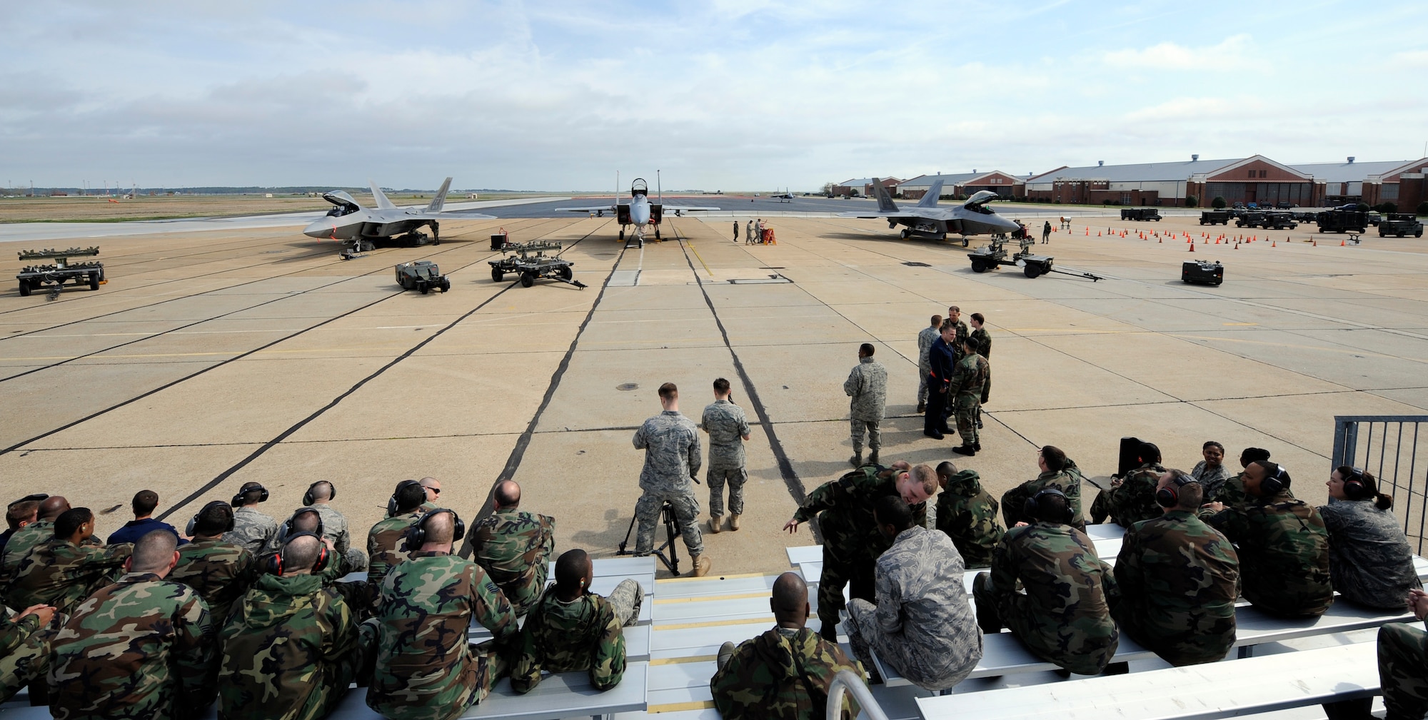 LANGLEY AIR FORCE BASE, Va. -- Airmen gather to watch a weapons loading competition on Langley’s flightline April 4. The weapons loading competition, commonly referred to as “loadio,” is conducted to sharpen the skills of weapons loaders to ensure that their job is done quickly and without mistakes. (U.S. Air Force photo/Senior Airman Christopher L. Ingersoll)