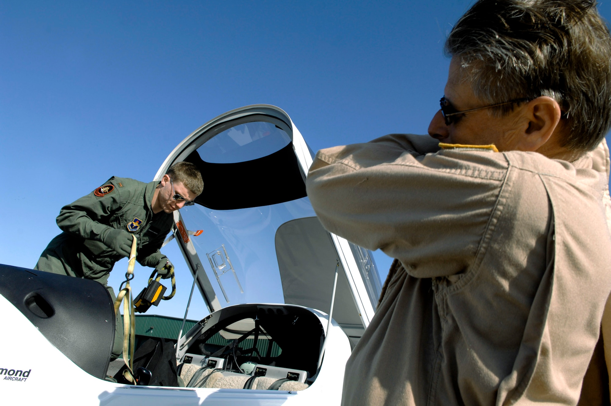 Student pilot 2nd Lt. Brandon Magnuson deplanes from a DA-20 aircraft after performing his first solo flight with instructor pilot Greg Dotter April 7 in Pueblo, Colo.  The Doss Aviation Initial Flight Screening Course held there is used to screen Air Force aviation candidates and develop student's aviation skills. (U.S. Air Force photo/Tech. Sgt. Cecilio Ricardo) 