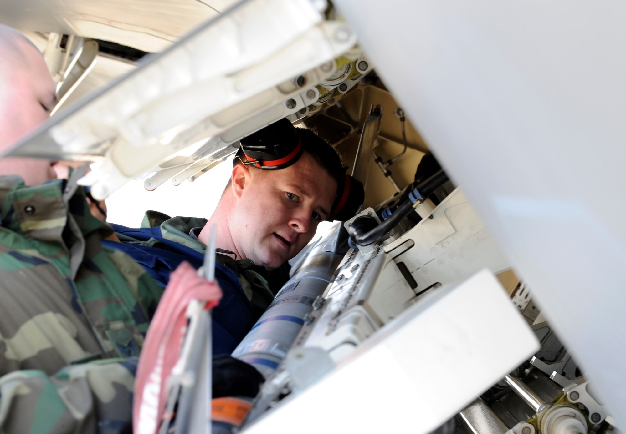 LANGLEY AIR FORCE BASE, Va. -- Staff Sgt.  Tiegh Tinsley of the 1st Aircraft Maintenance Squadron checks to ensure a missile is properly secured during a weapons loading competition April 4. The weapons loading competition, commonly referred to as “loadio,” is conducted to sharpen the skills of weapons loaders to ensure that their job is done quickly and without mistakes. (U.S. Air Force photo/Senior Airman Christopher L. Ingersoll)