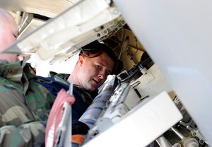 LANGLEY AIR FORCE BASE, Va. -- Staff Sgt.  Tiegh Tinsley of the 1st Aircraft Maintenance Squadron checks to ensure a missile is properly secured during a weapons loading competition April 4. The weapons loading competition, commonly referred to as “loadio,” is conducted to sharpen the skills of weapons loaders to ensure that their job is done quickly and without mistakes. (U.S. Air Force photo/Senior Airman Christopher L. Ingersoll)