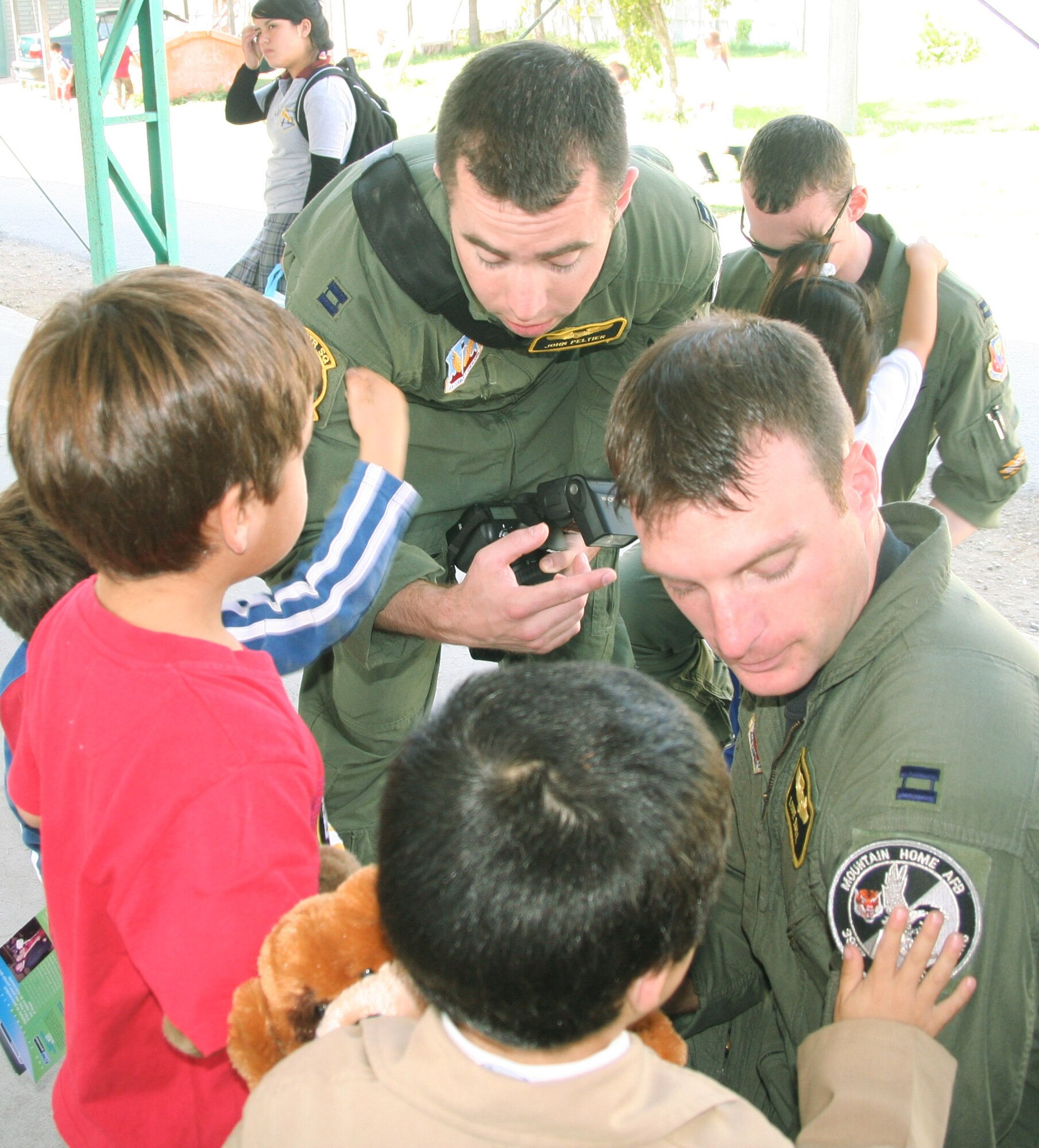 Capts. John Peltier and Luke Ball show off their squadron patches to Chilean orphans at Koinomadelfia Orphanage April 3 west of Santiago, Chile. The captains supported the largest South American air show, FIDAE, where they showcased F-15E Strike Eagles to international audiences. Captains Peltier and Ball are assigned to the 391st Fighter Squadron from Mountain Home Air Force Base, Idaho. (U.S. Air Force photo/1st Lt. Candace Cutrufo) 
