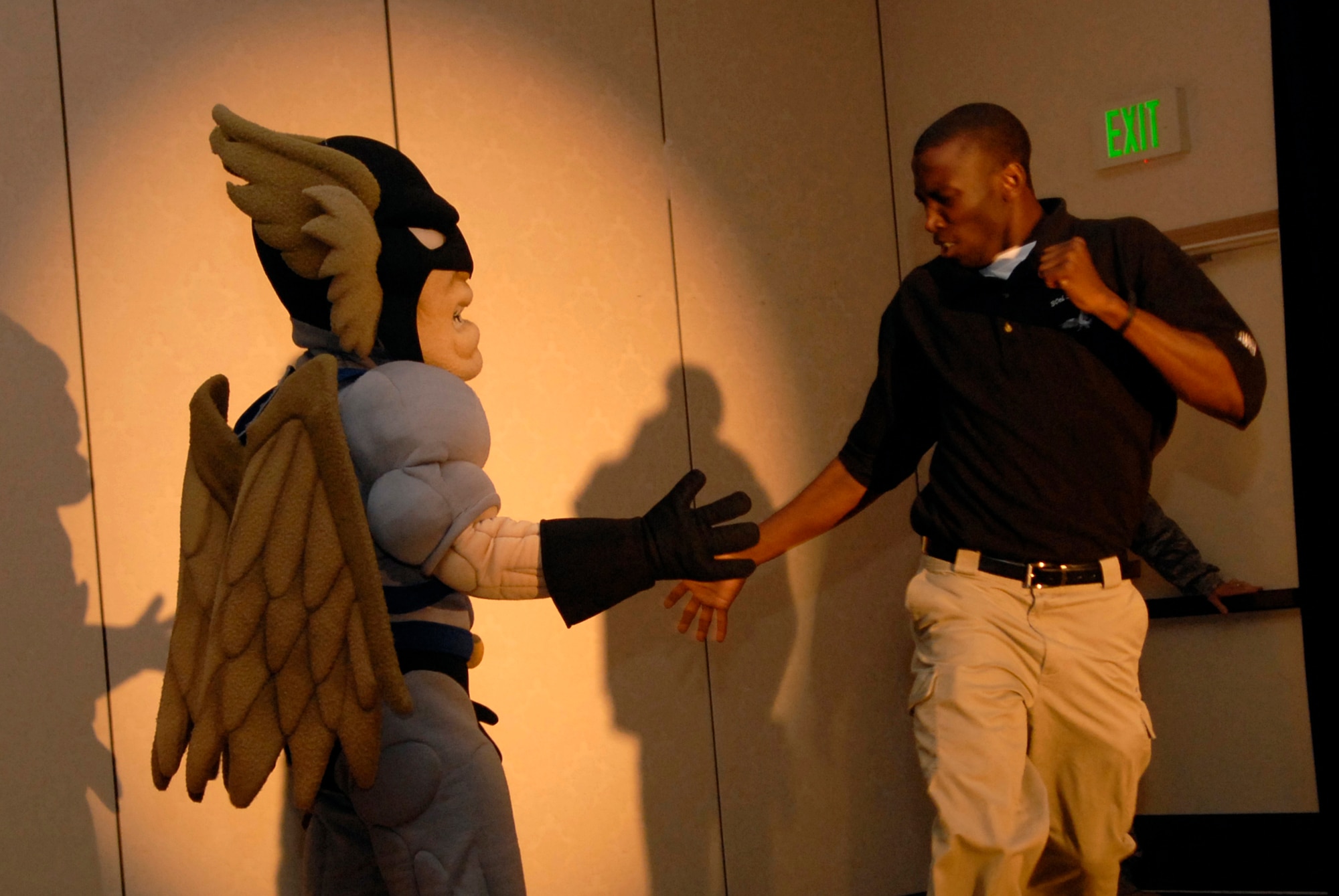 VANDENBERG AIR FORCE BASE, Calif. -- Staff Sgt. Anthoney Kilgore, a infrastructure specialist with the 30th Launch Support Squadron, celebrates with Vandenberg's mascot, Hawkman, after he is announced as a Guardian Challenge team member during the kickoff event April 4. The event was held to present the team to the 30th Space Wing and to provide the team with competition uniforms. Guardian Challenge in the only space and missile competition in the Air Force. (U.S. Air Force photo/Airman 1st Class Christian Thomas) 
