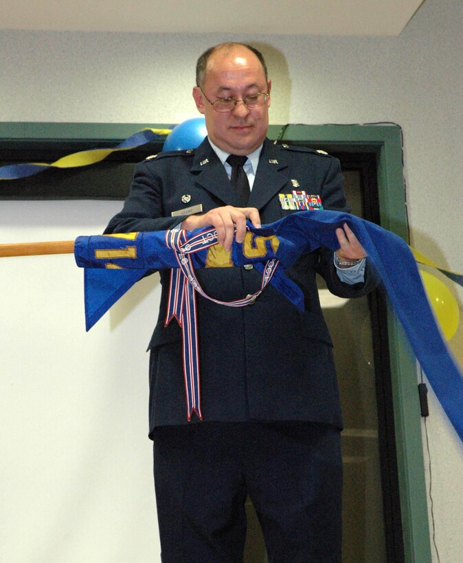 MCGUIRE AIR FORCE BASE, N.J. - Lt. Col. Bruce Adams, final commander of the 714th Aeromedical Evacuation Squadron, furls the squadron flag for the last time.  The Air Force Reserve unit, tasked to provide worldwide in-flight medical aid to the sick and injured, ends 14 years of activation at McGuire Air Force Base. N.J. (U.S. Air Force photo/Master Sgt. Chuck Kramer)