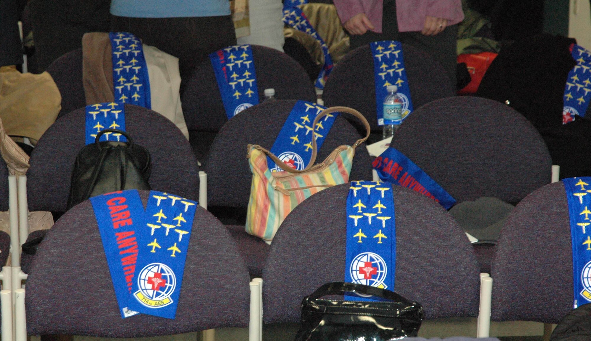 MCGUIRE AIR FORCE BASE, N.J. -- 714th Aeromedical Evacuation Squadron scarves adorn the chairs of unit members during the squadron's deactivation ceremony on March 29.  Activated since October 1994, the Reserve members particpated in numerous worldwide missions. Their task of providing care to sick and injured shows credence to the unit slogan "Patient Care Anywhere" as printed in bold red letters on the scarves..  (U.S. Air Force photo/Master Sgt. Chuck Kramer)