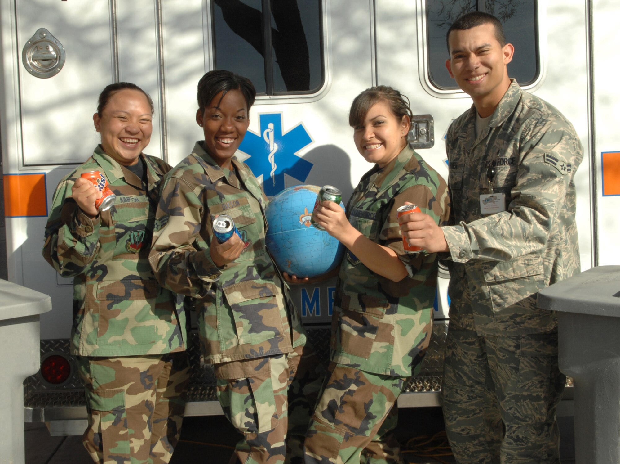 NELLIS AIR FORCE BASE, Nev. -- Senior Airmen Rosenda Kimpton, Tamika Dixson, Patricia Villalobos, 99th Medical Operations Squadron cardiopulmonary technicians, and Airman 1st Class Alexander Turner, 99th Aerospace Medicine Squadron public health technician, show their dedication to improving the environment by initiating a “green to green” aluminum can recycling program at the Mike O'Callaghan Federal Hospital. All are officers of the MOFH Airman Council. The program consists of a month-long competition between clinics. Money collected for recycled goods will be used for morale-building activities. 
(U.S. Air Force Photo by Senior Airman Nadine Y. Barclay)

