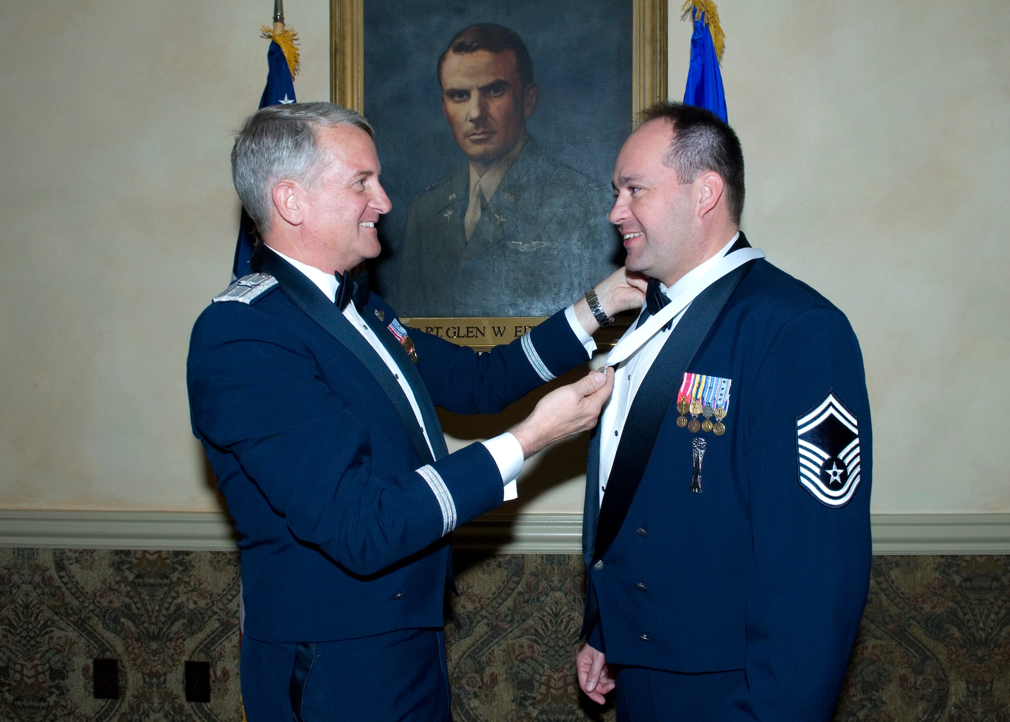 Brig. Gen. David Eichhorn, Air Force Flight Test Center commander, presents a medal to Senior Master Sgt. Ben Rosen, Air Force Research Laboratory propulsion division superintendent, during the Team Edwards Chief Recognition Ceremony at Club Muroc on April 4. Three new Team Edwards chiefs were recognized during the ceremony. (Air Force photo by Edward Cannon)