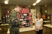 BISMARCK, N.D. -- Samantha Yatzeck, a student at Minot AFB Memorial Junior High School, is questioned by Airman 1st Class Benjamin Stratton of Minot AFB about her project on Rosa Parks at the National History Day North Dakota State Contest 2008, held April 4 in Bismarck, N.D. The contest served to commemorate important historical events of our time. (U.S. Air Force photo by Airman 1st Class Jesse Lopez) 