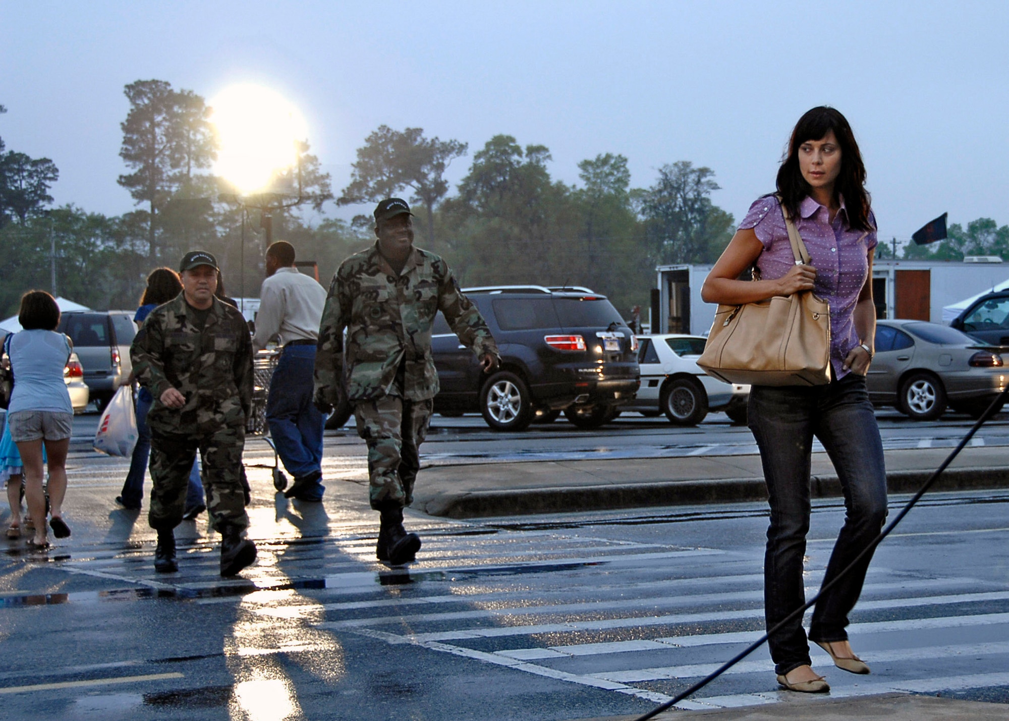 Tech. Sgt. Erwin Arguilla and Staff Sgt. Jeffrey Graham follow Catherine Bell while filming a scene for an upcoming episode of "Army Wives" April 7 on Charleston Air Force Base, S.C. Sergeants Arguilla and Graham both work in the 437th Airlift Wing Safety Office. Ms. Bell plays Lt. Col. Sarah MacKenzie for the Lifetime show "Army Wives." (U.S. Air Force photo/Airman 1st Class Katie Gieratz) 
