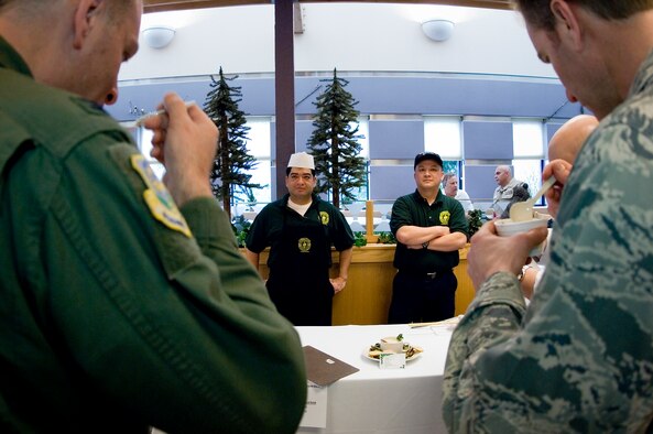 Naval Hospital Bremerton Sailors wait for a reaction from contest judge Col. Shane Hershman, 62nd Airlift Wing vice commander, left, and Lt. Col. Eric Payne, 62nd Mission Support Group, during the judging portion of the competition. (U.S. Air Force photo/Abner Guzman) 
