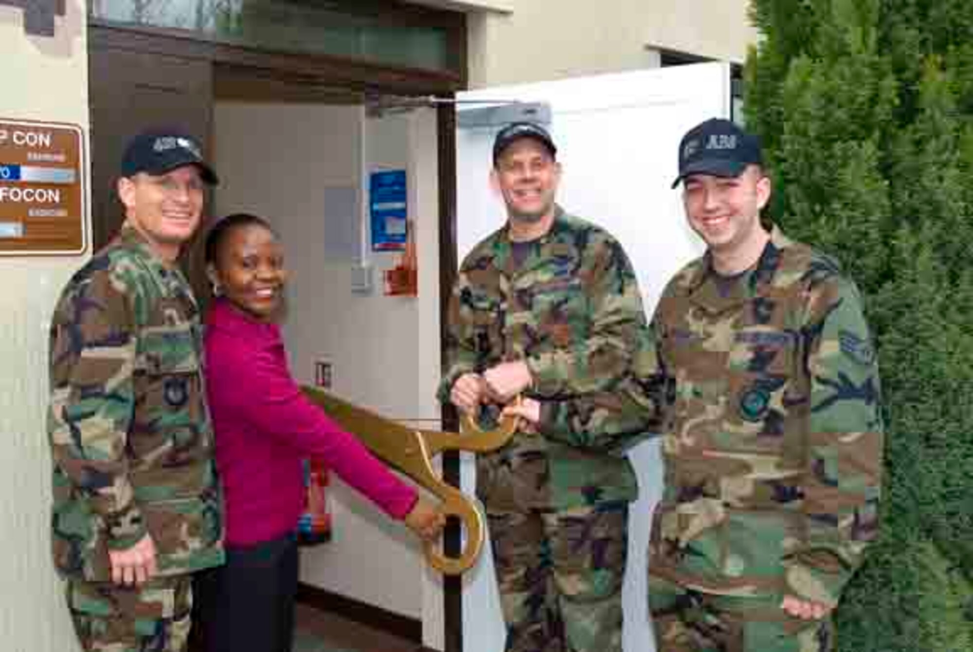 Lt. Col Ryan Price, 420th Air Base Squadron commander, Education Advisor Joyce Njoroge, Col. Joseph Dill, 420th Air Base Group ommander and Education and Training Manager Staff Sgt. Brian Nadreau cut the ceremonial ribbon on the new education center at RAF Fairford.  (U.S. Air Force photo by Senior Master Sgt. Jon Nicolussi)
