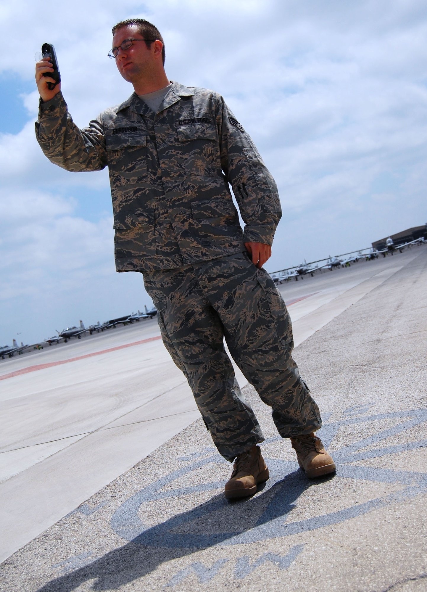 LAUGHLIN AIR FORCE BASE, Texas – Senior Airman Zachary Ferguson, 47th Operations Support Squadron, weather flight, takes a manual observation with a Kestral to measure the wind speed and direction, temperature, dew point and heat index, while standing in the center of a compass rose on the flight line April 7. As a weather technician, Airman Ferguson’s job is to help give an accurate forecast of the weather so pilots here can fly safely and be prepared for pending weather conditions. He also helps put out weather warnings and watches to base members. “My job is interesting,” said Ferguson. “I really like it when the weather’s bad though.” (U.S. Air Force photo by Airman 1st Class Sara Csurilla)