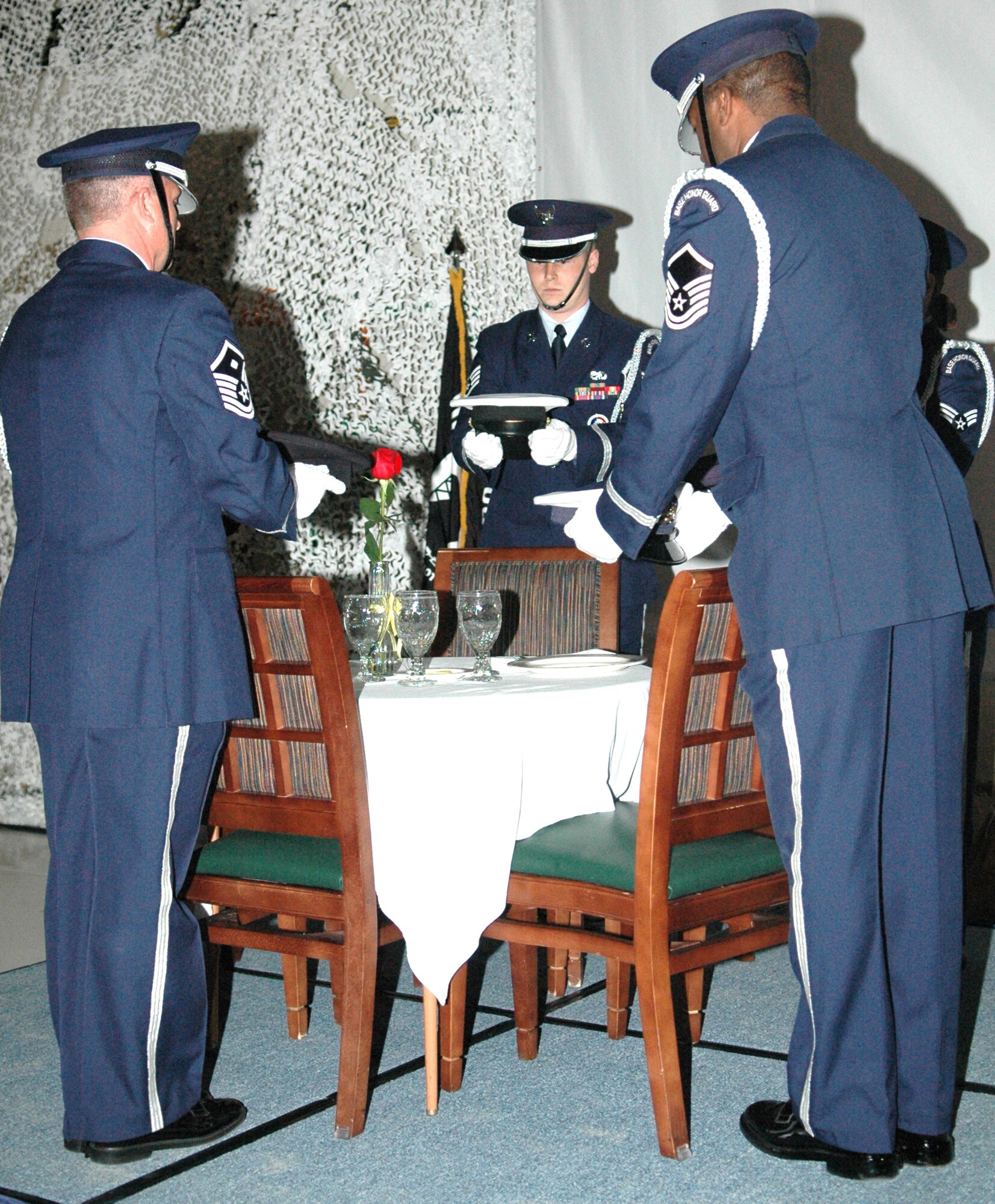GRISSOM AIR RESERVE BASE, Ind., -- Members of the Grissom Honor Guard prepare a commemorative POW/MIA table during the opening ceremonies of the Grissom Military Ball. The event was held in celebration of the Air Force Reserve's 60th Anniversary. (U.S. Air Force photo/Senior Airman Ben Mota)