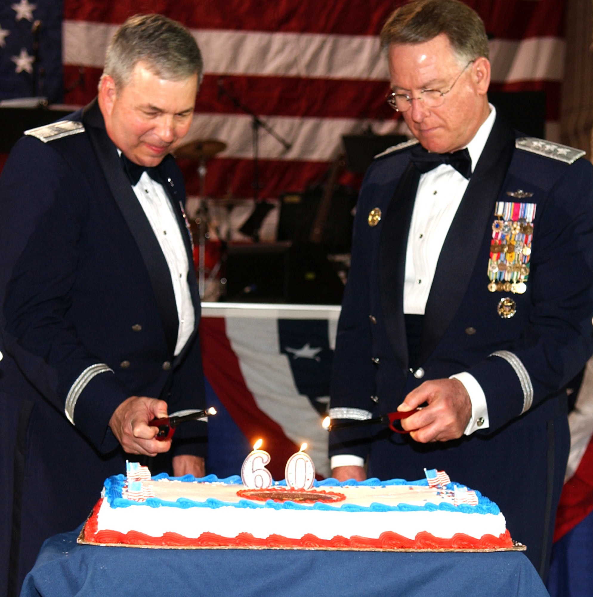 GRISSOM AIR RESERVE BASE, Ind., -- Lt. Gen. John Bradley, right, Air Force Reserve Command commander, and Brig. Gen. Dean Despinoy, 434th Air Refueling Wing commander, light the candles to commemorate the 60th Anniversary of the U.S. Air Force Reserve. In celebration of the milestone, Grissom held a military ball and General Bradley was the honored guest.(U.S. Air Force photo/Senior Airman Carl Berry)